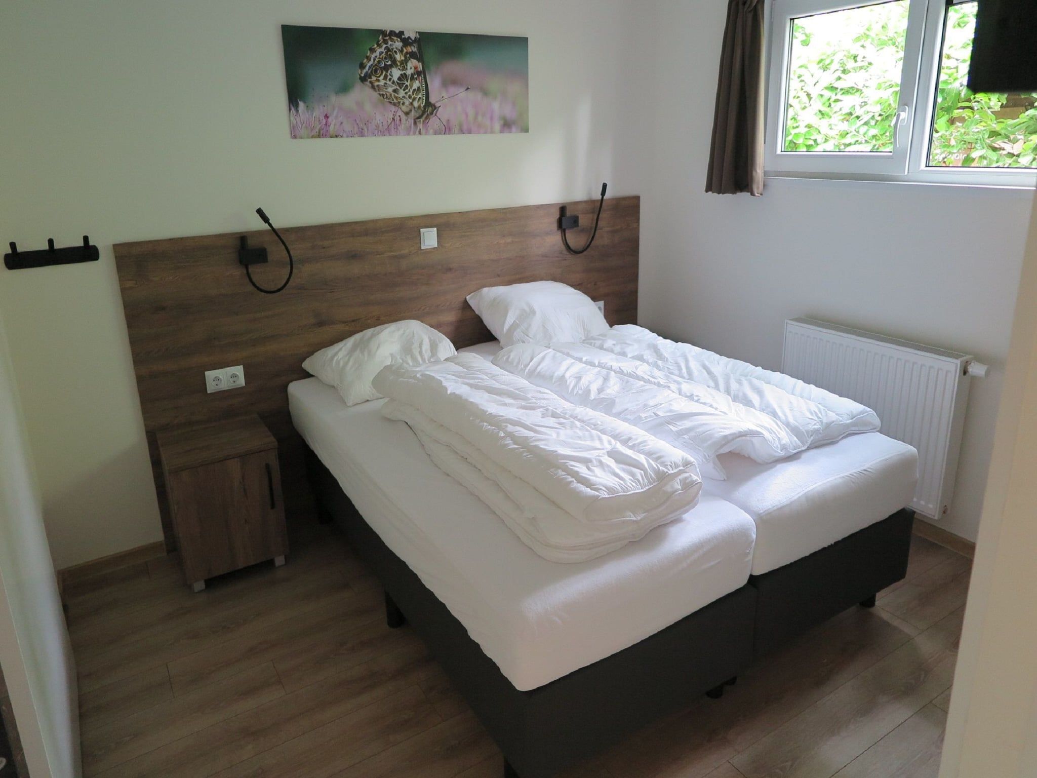 Een slaapkamer van Vakantiepark De Rimboe & De Woeste Hoogte 25 in Hoenderloo