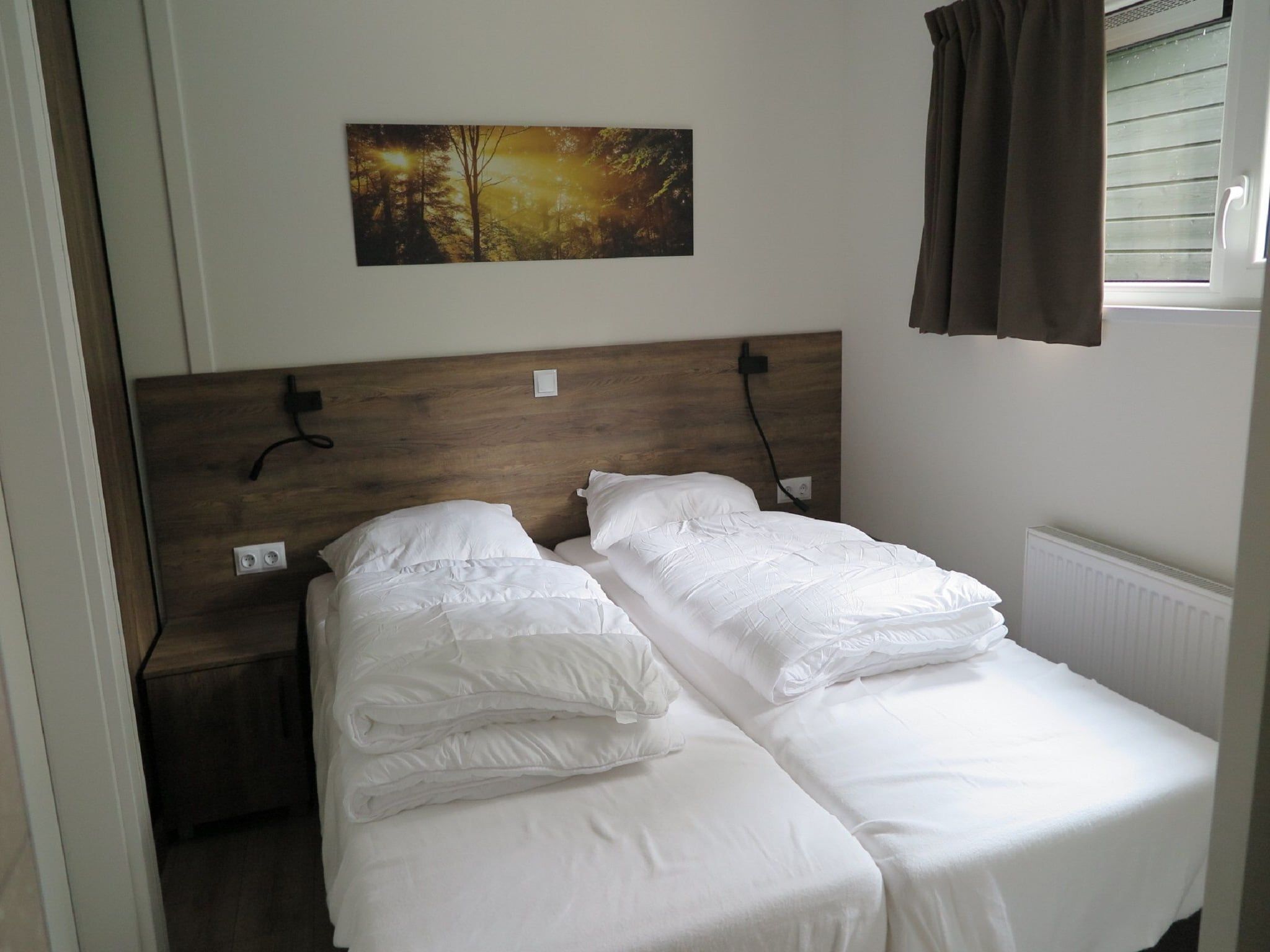 Een slaapkamer van Vakantiepark De Rimboe & De Woeste Hoogte 25 in Hoenderloo