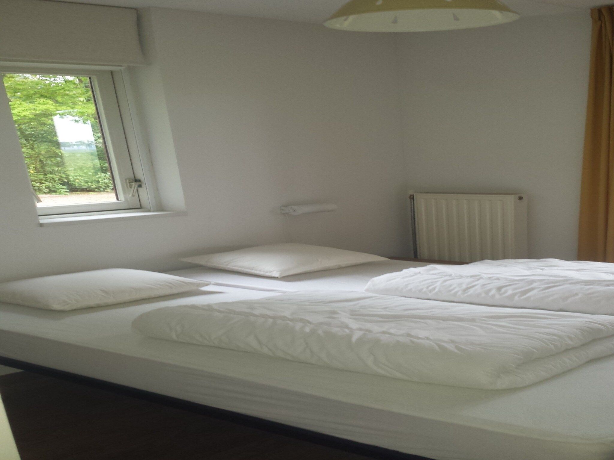 Een slaapkamer van Buitenplaats Berg en Bos nummer 18 in Lemele