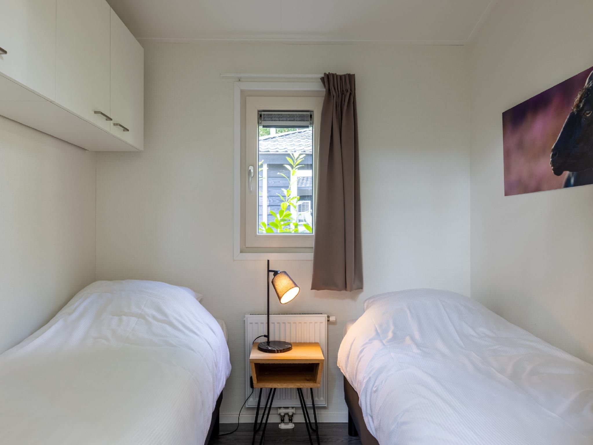 Een slaapkamer van Vakantiepark De Rimboe & De Woeste Hoogte 27 in Hoenderloo