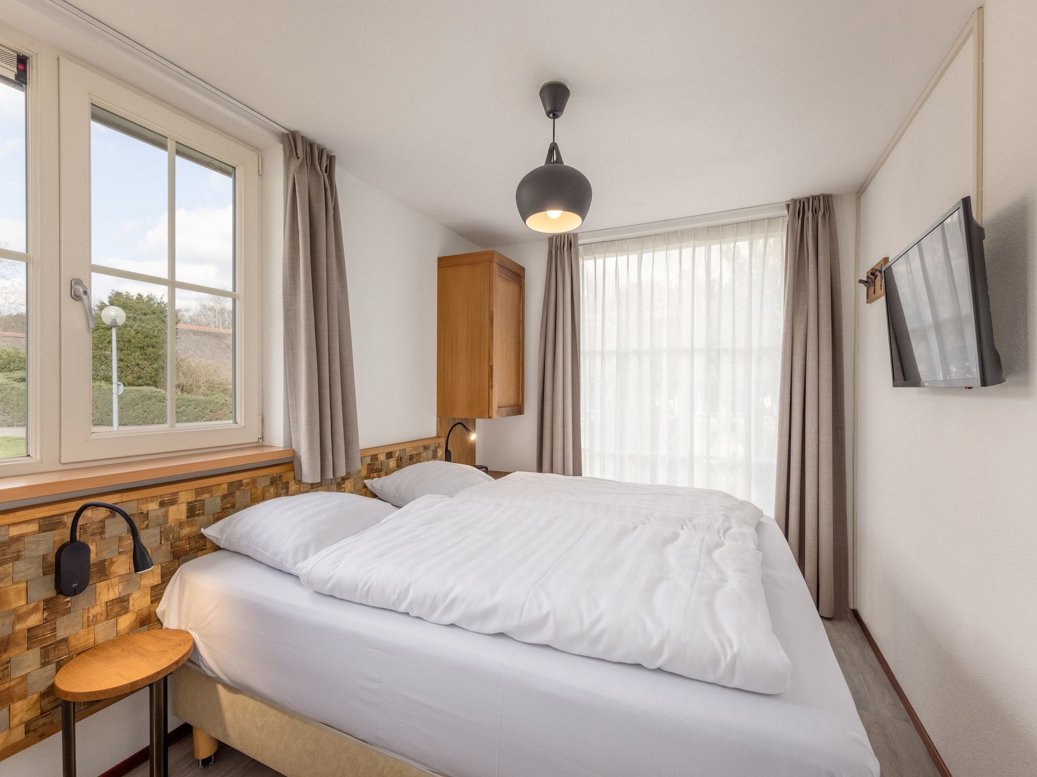 Een slaapkamer van De Veluwse Hoevegaerde 5 in Putten