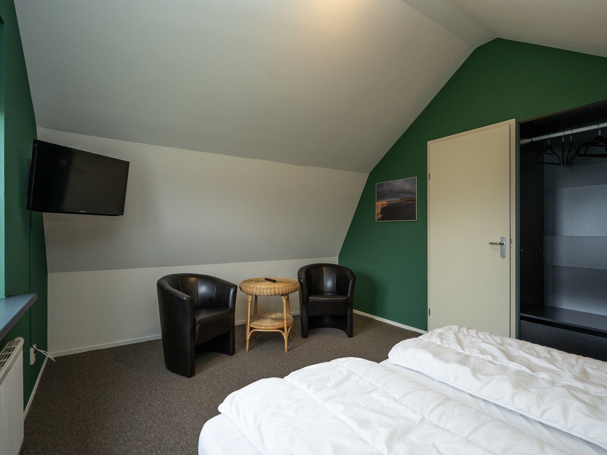 Een slaapkamer van Vakantiepark 't Eibernest Texel 7 in De Cocksdorp