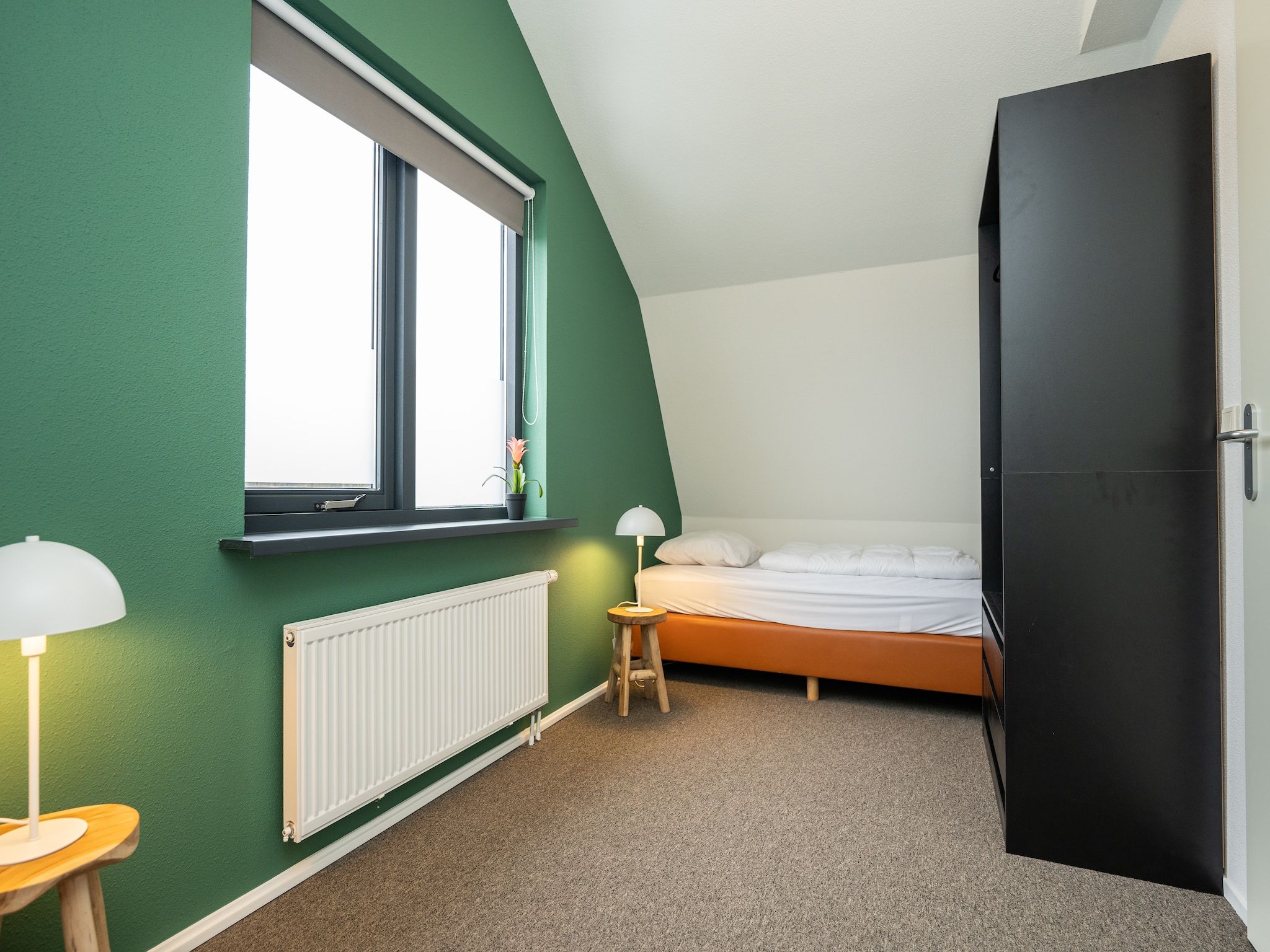 Een slaapkamer van Vakantiepark 't Eibernest Texel 7 in De Cocksdorp