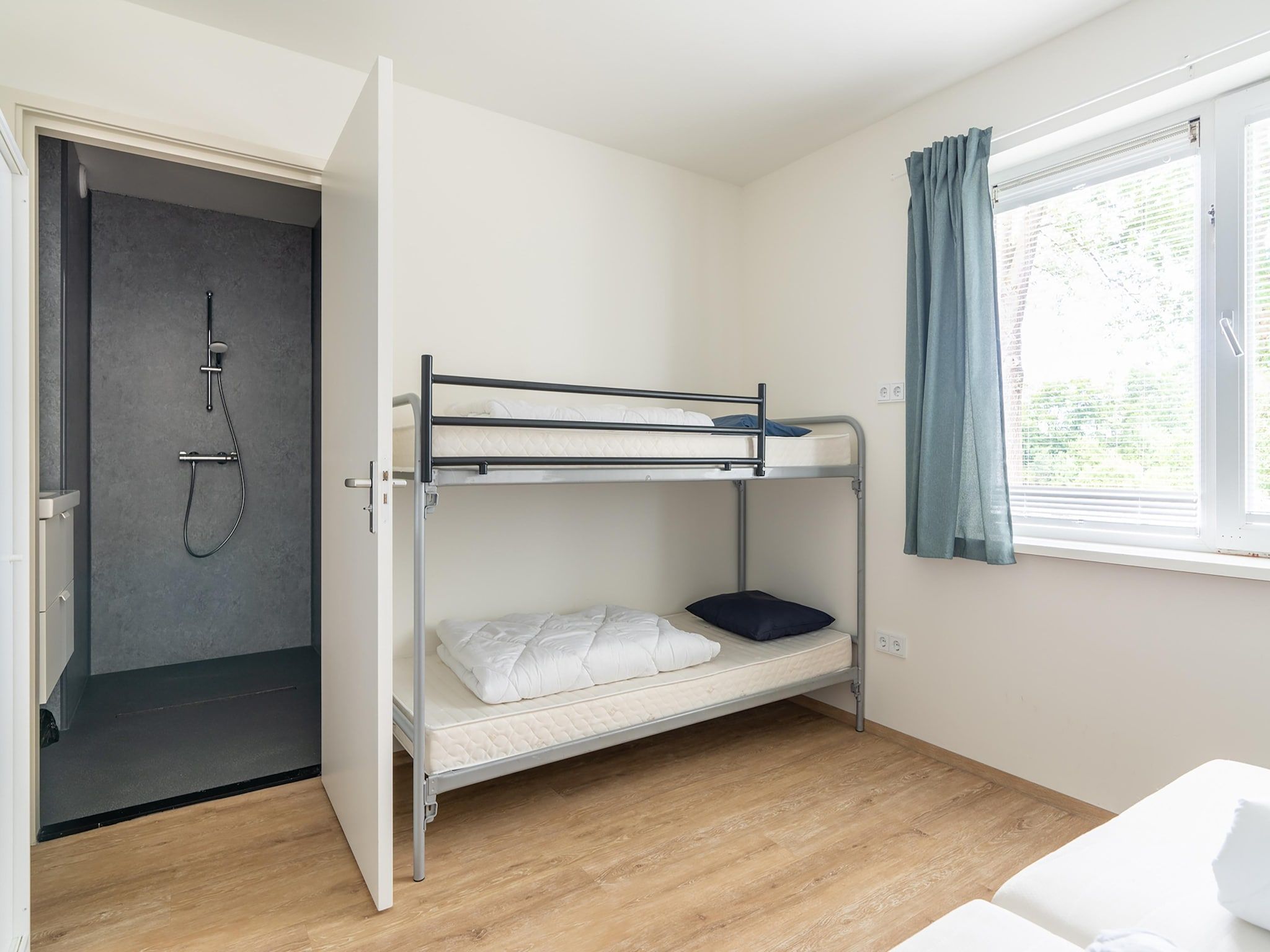 Een slaapkamer van Combi Vrijersduin en Kaapsduin in Nes