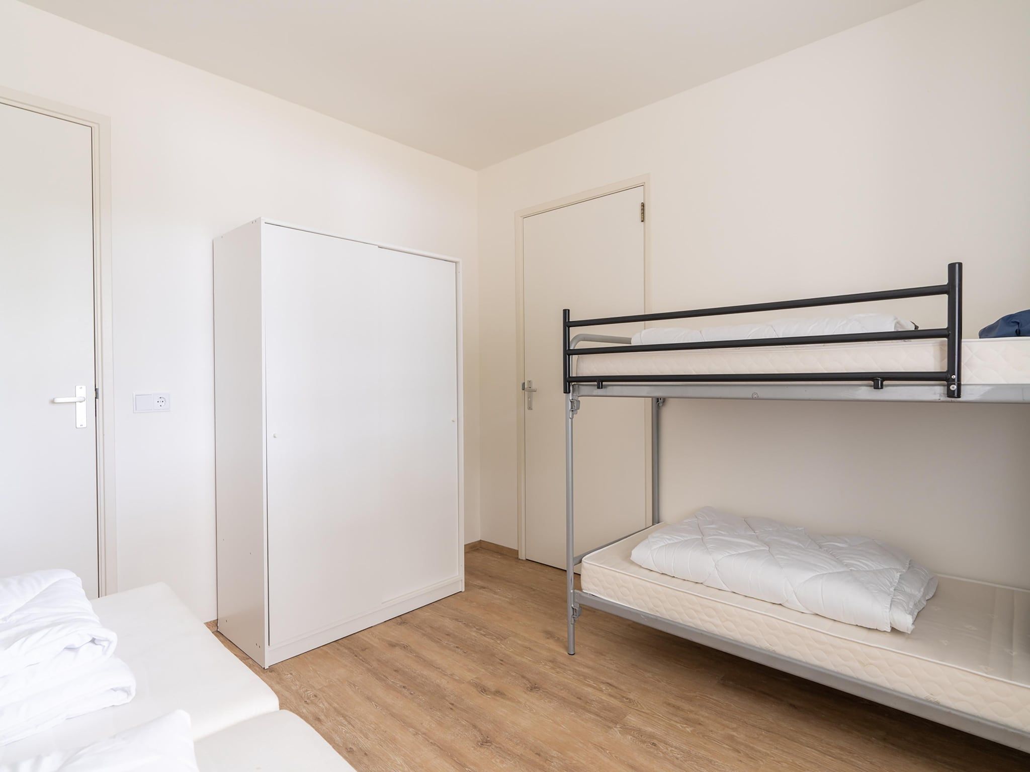 Een slaapkamer van Combi Vrijersduin en Kaapsduin in Nes