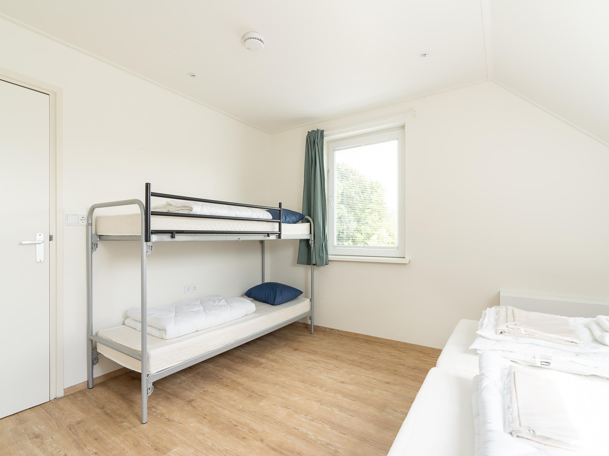 Een slaapkamer van Combi Vrijersduin en Kaapsduin in Nes