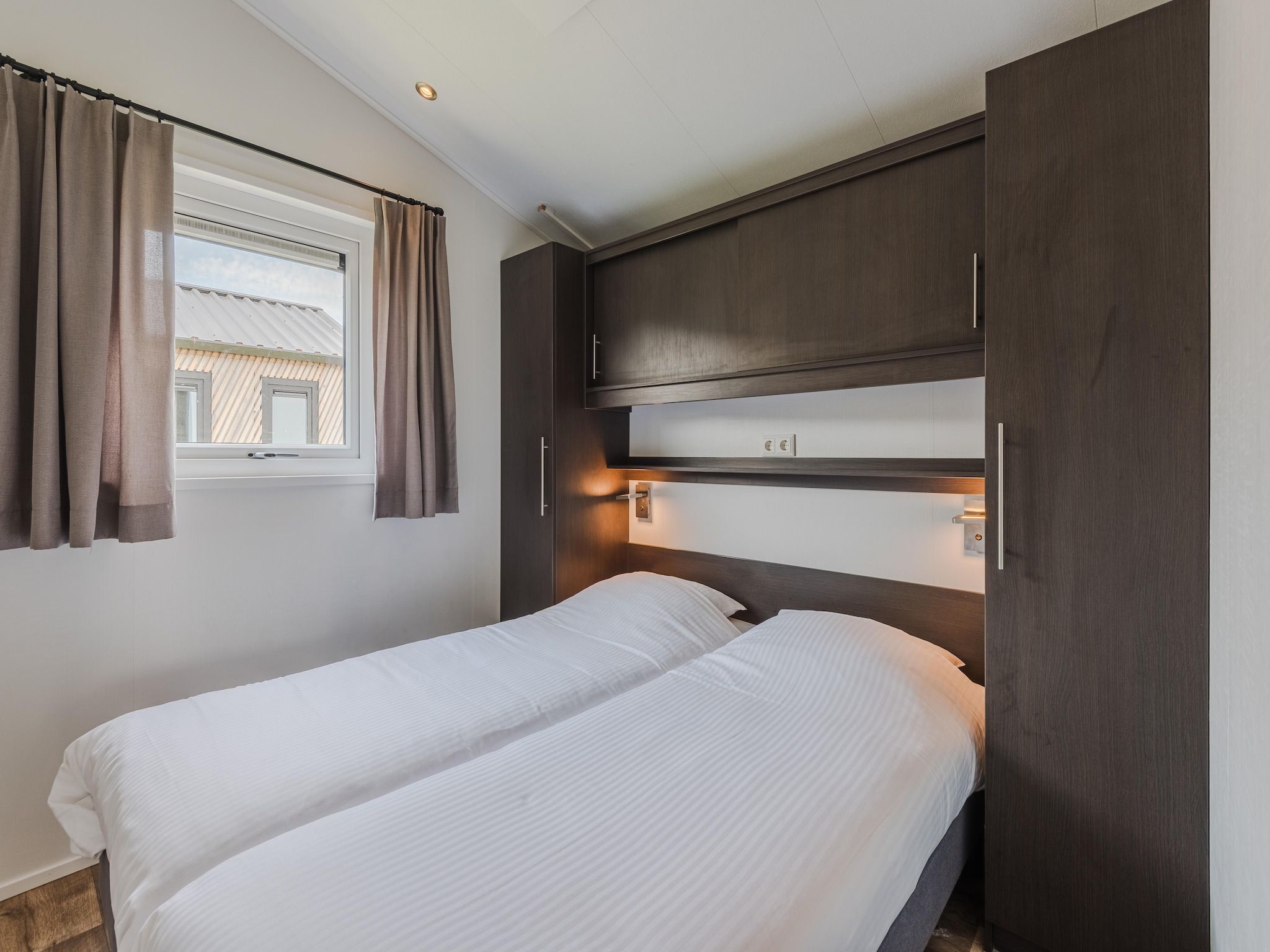 Een slaapkamer van Vakantiepark Giethoorn 11 in Giethoorn