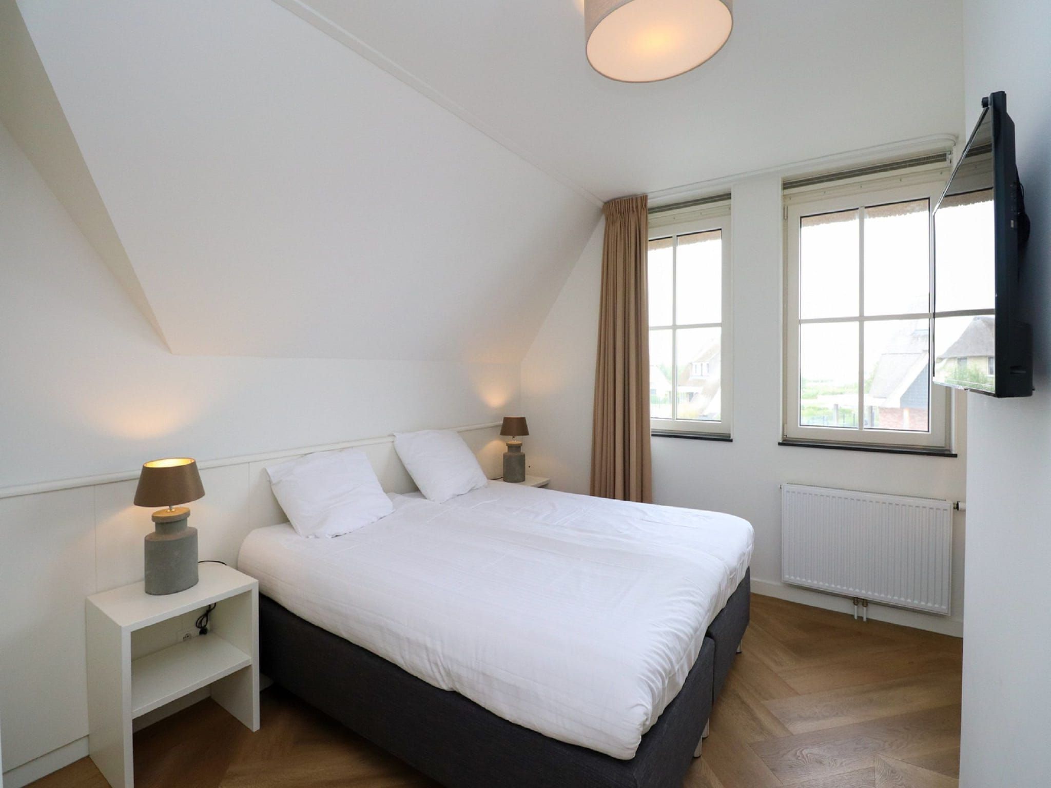 Een slaapkamer van Friese Meren Villa's 16 in Delfstrahuizen