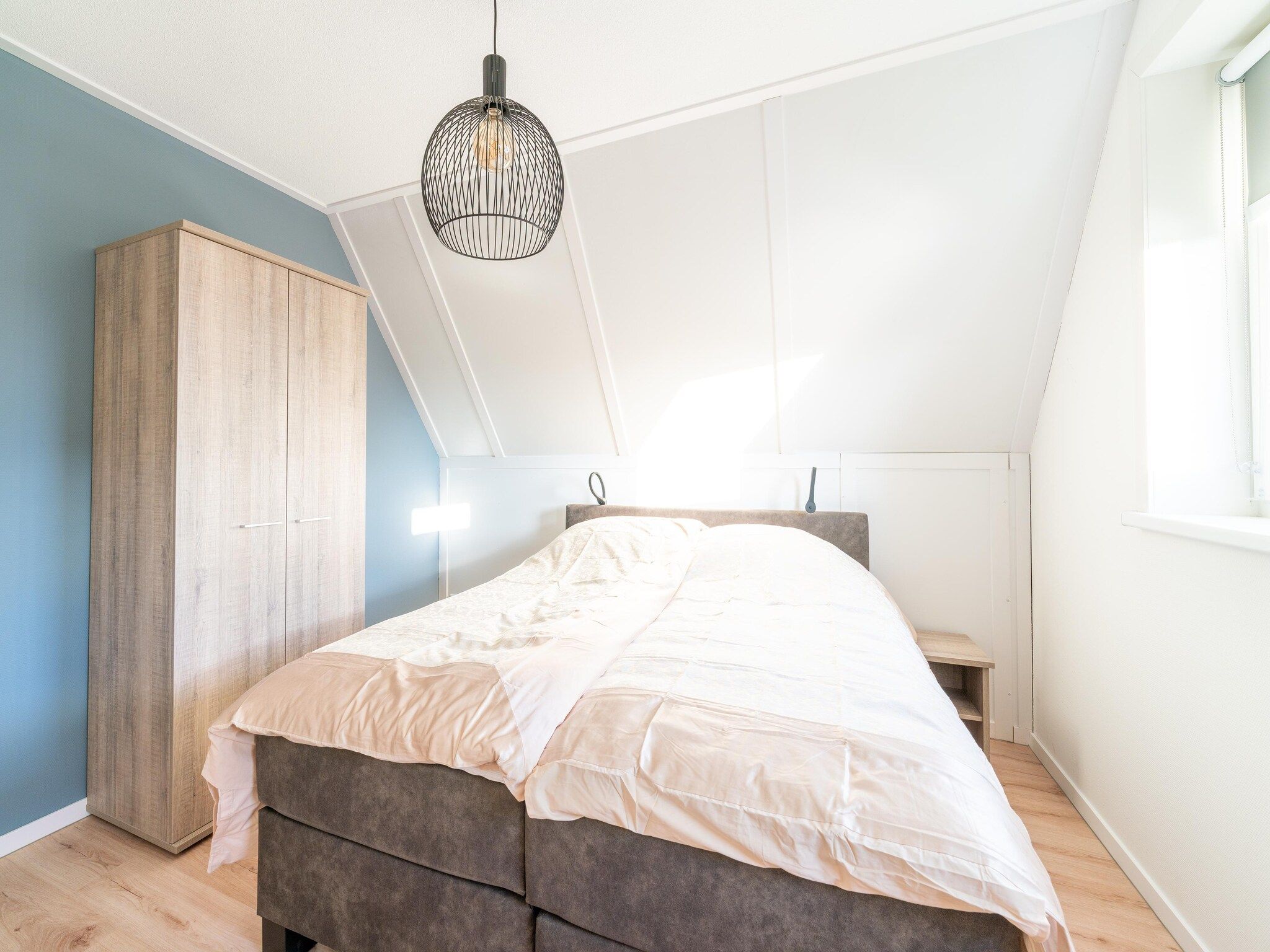 Een slaapkamer van De Ooievaar Huis NR 23 in Scherpenisse