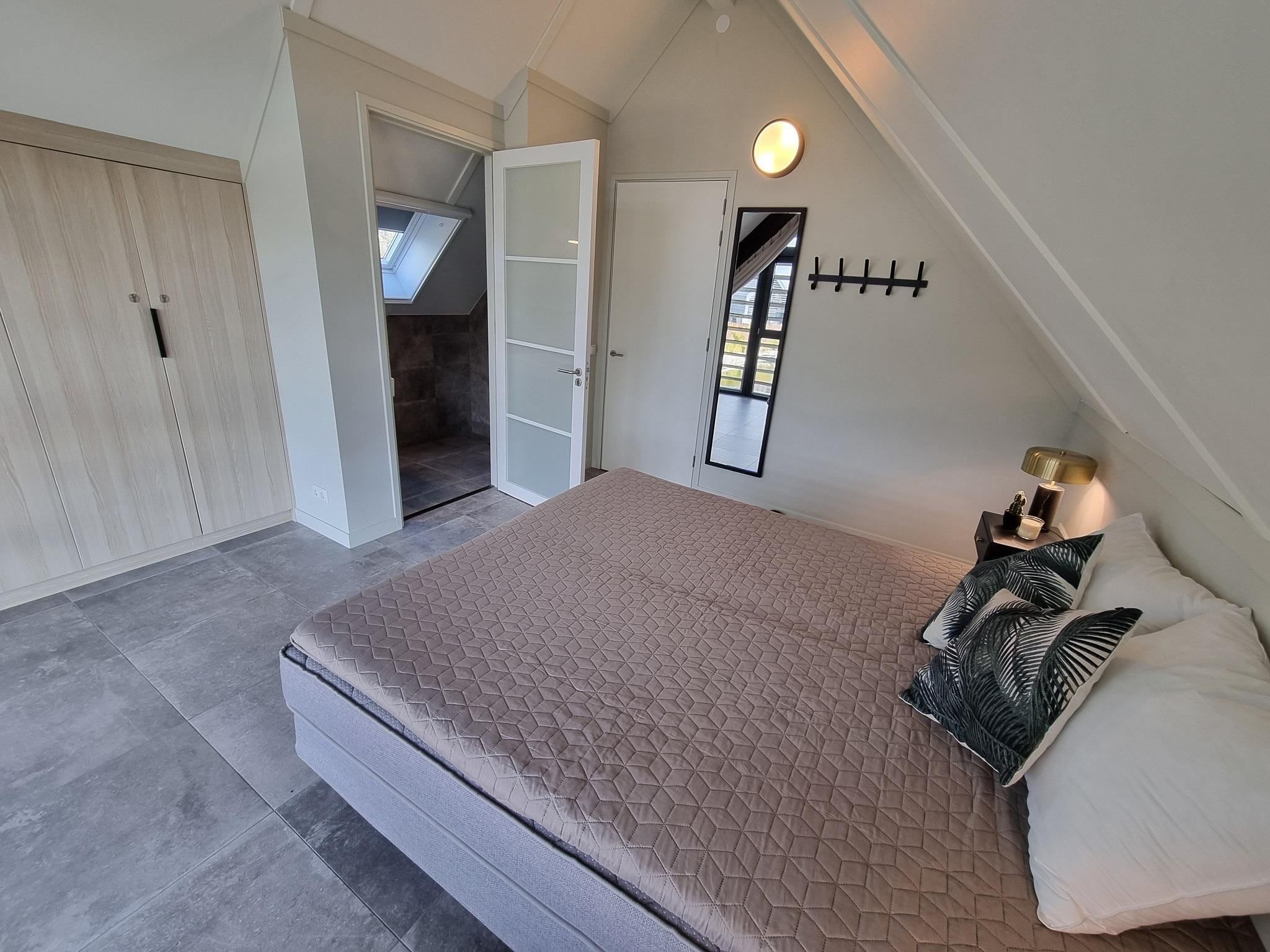 Een slaapkamer van Watervilla Ien in Balk