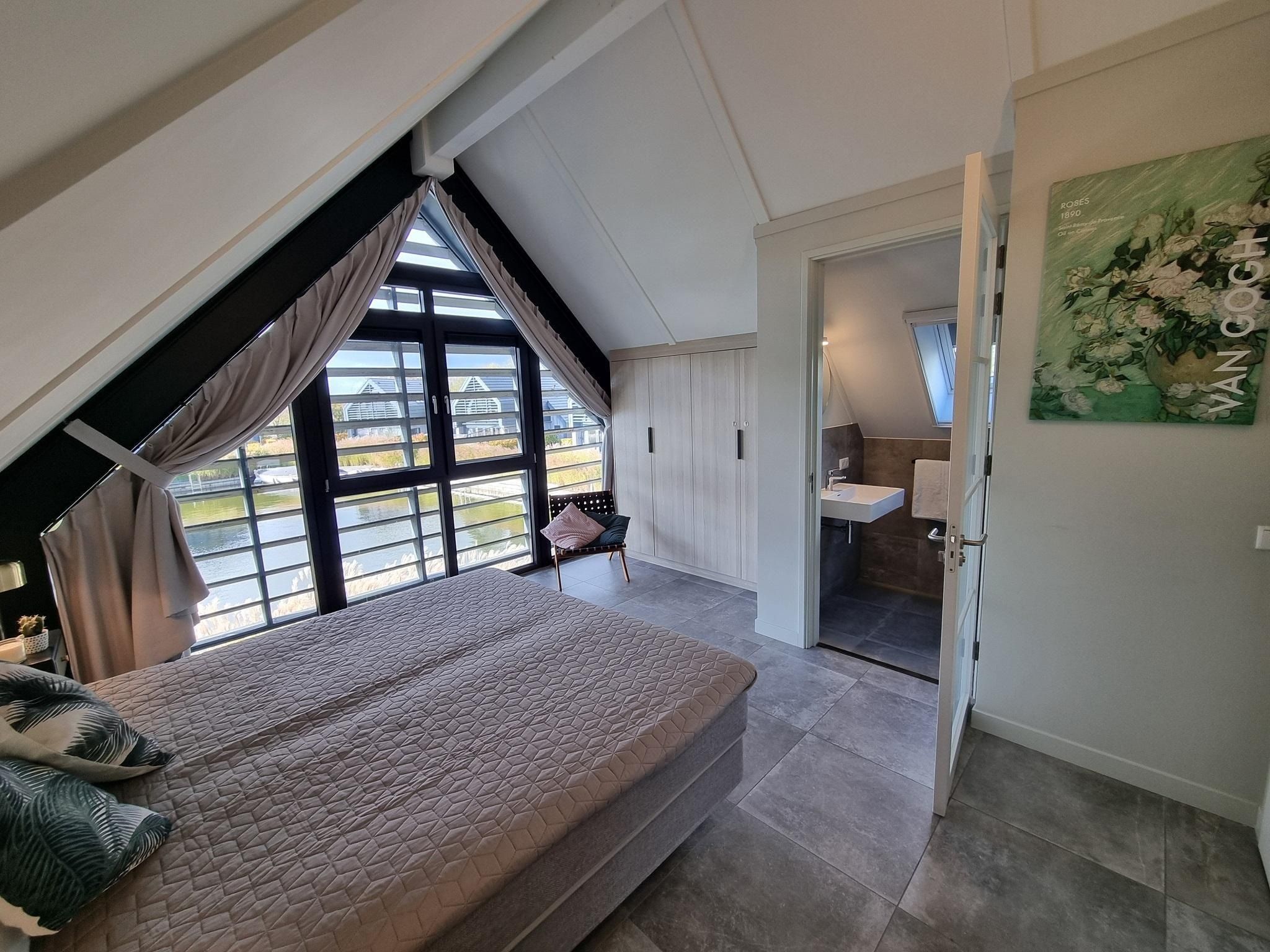 Een slaapkamer van Watervilla Ien in Balk