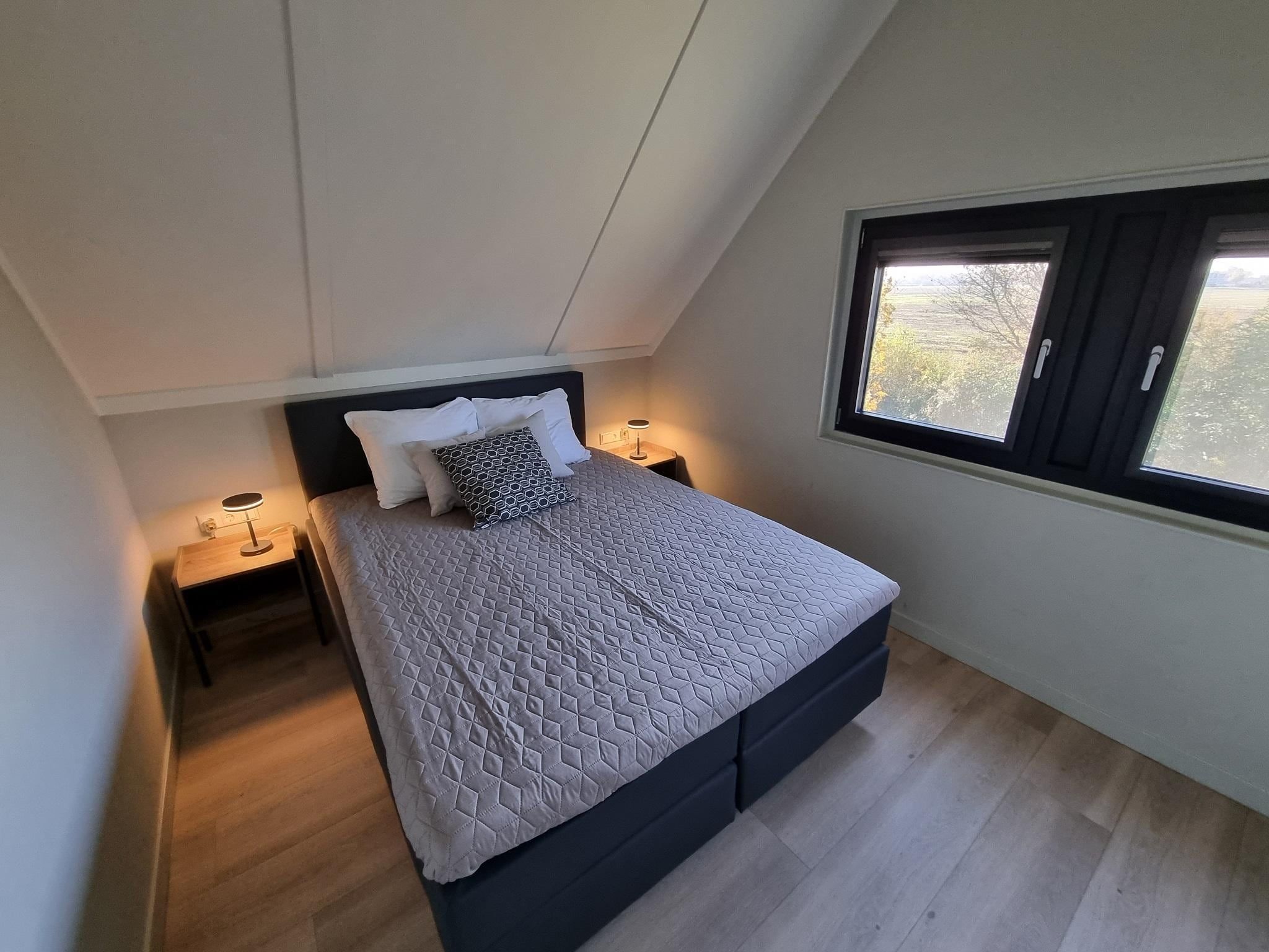 Een slaapkamer van Watervilla Ien in Balk