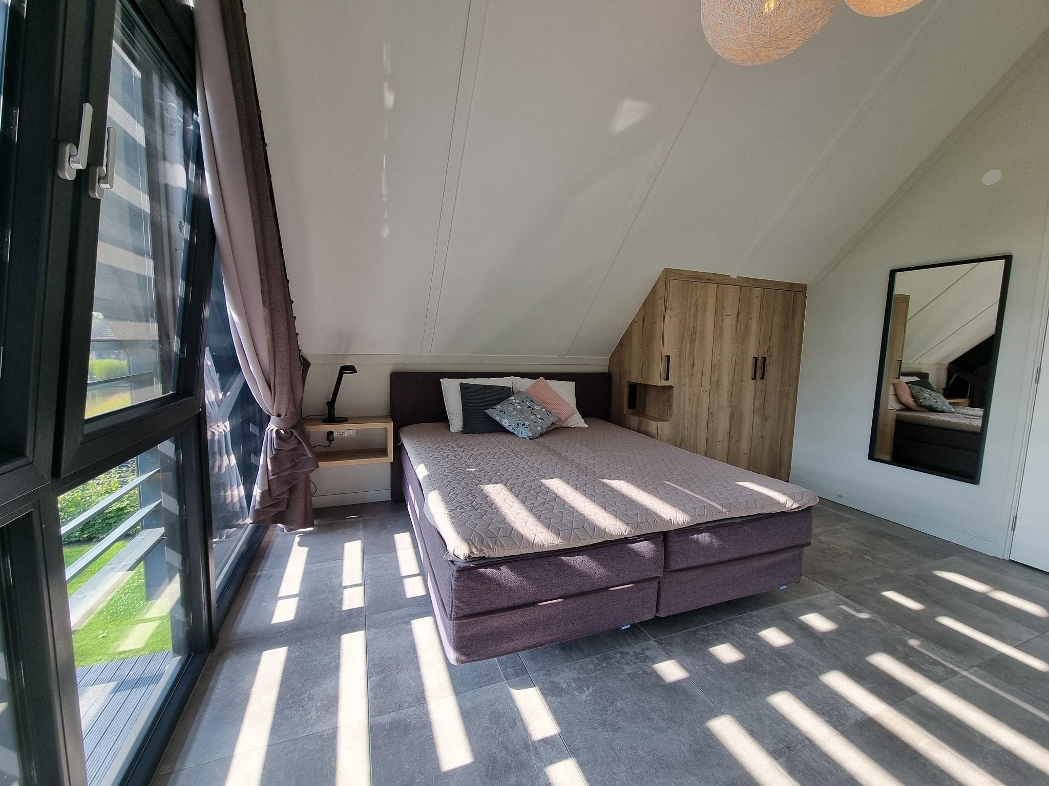 Een slaapkamer van Watervilla Tweintich in Balk