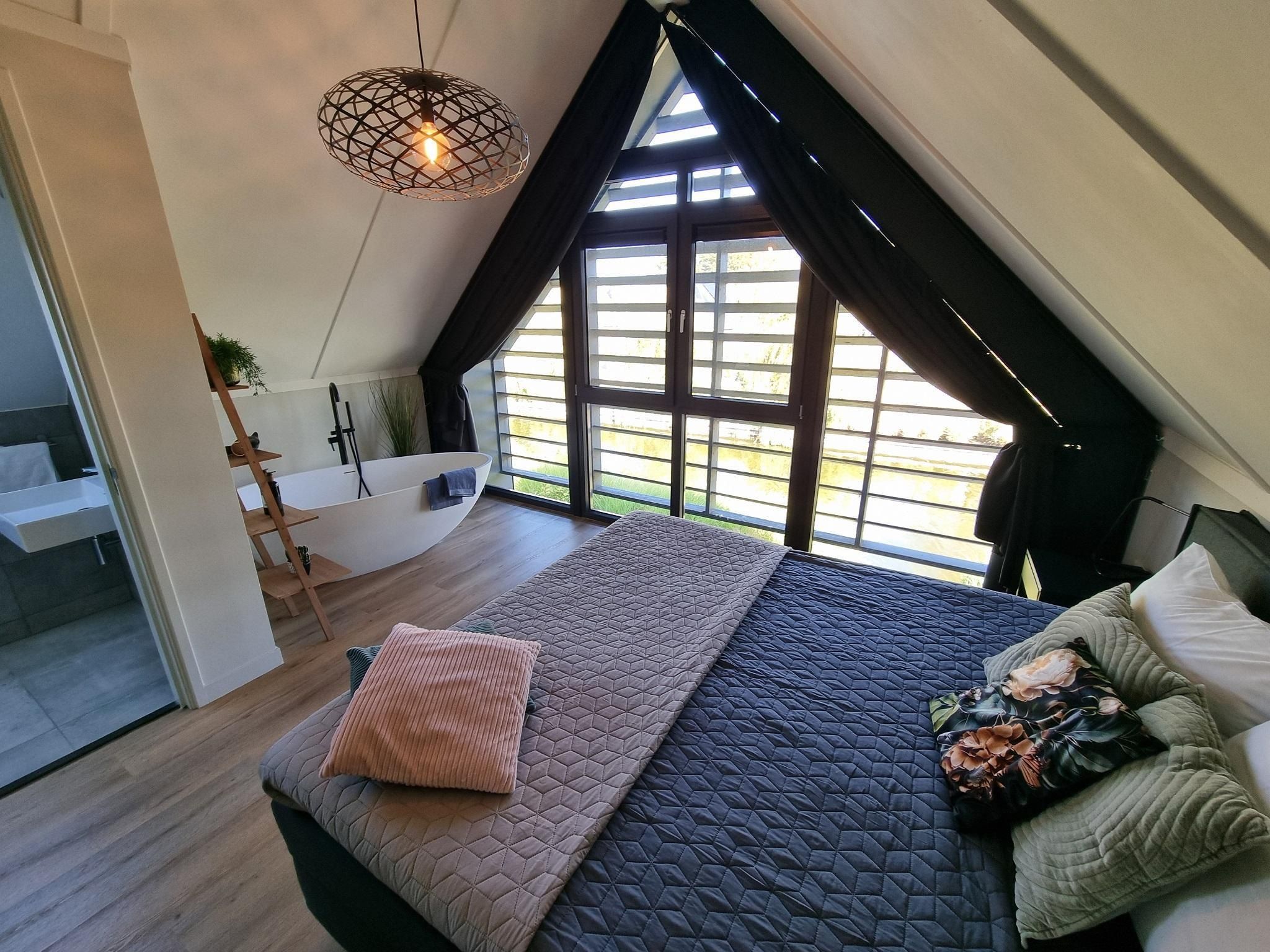 Een slaapkamer van Watervilla Alve in Balk