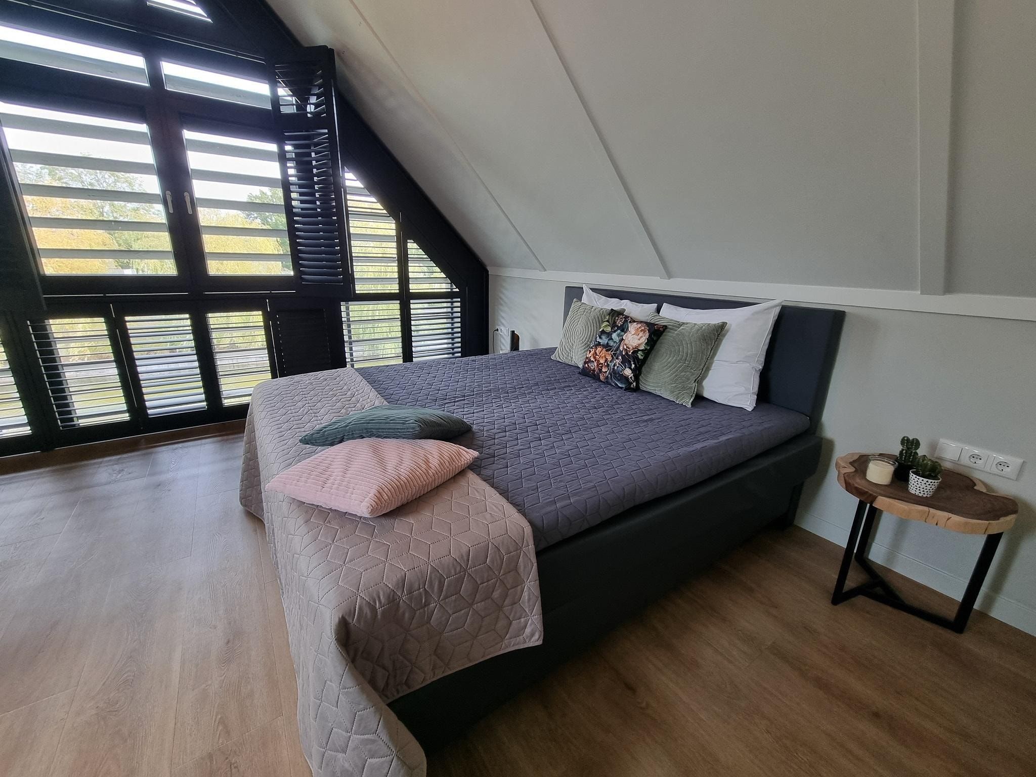 Een slaapkamer van Watervilla Trettjin in Balk