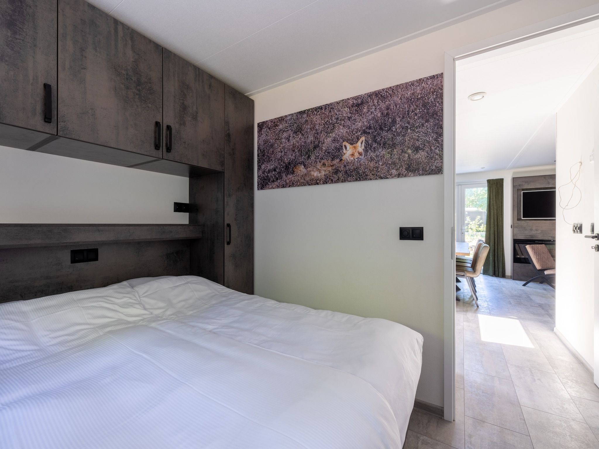 Een slaapkamer van Vakantiepark De Rimboe & De Woeste Hoogte 38 in Hoenderloo