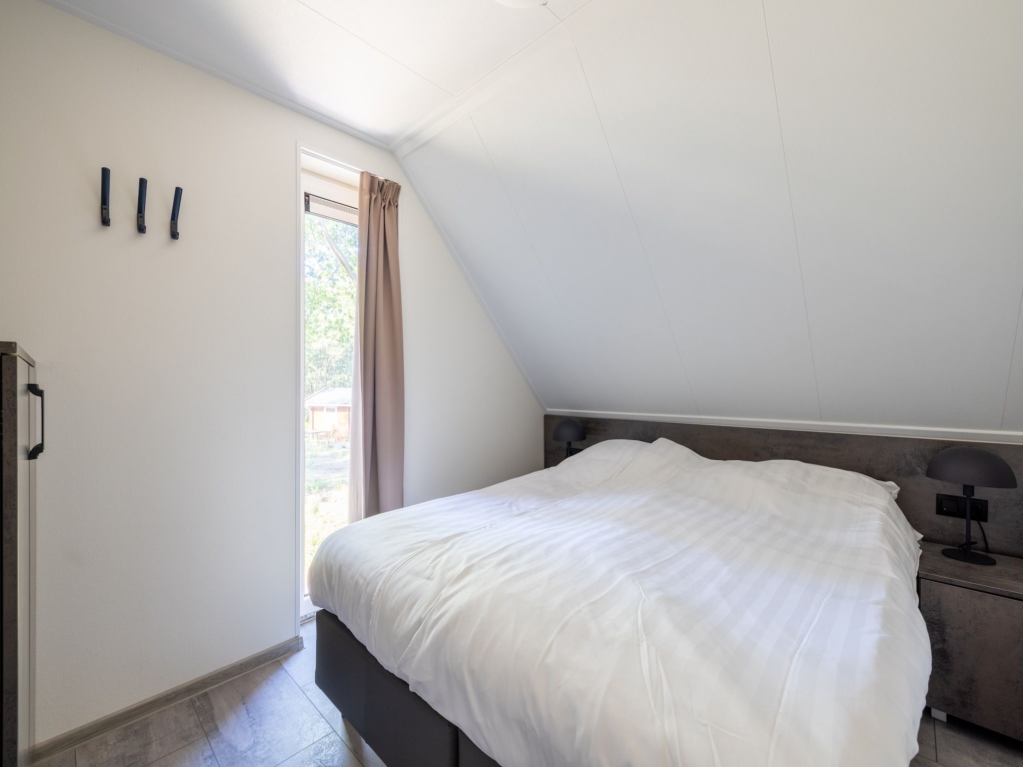 Een slaapkamer van Vakantiepark De Rimboe & De Woeste Hoogte 38 in Hoenderloo