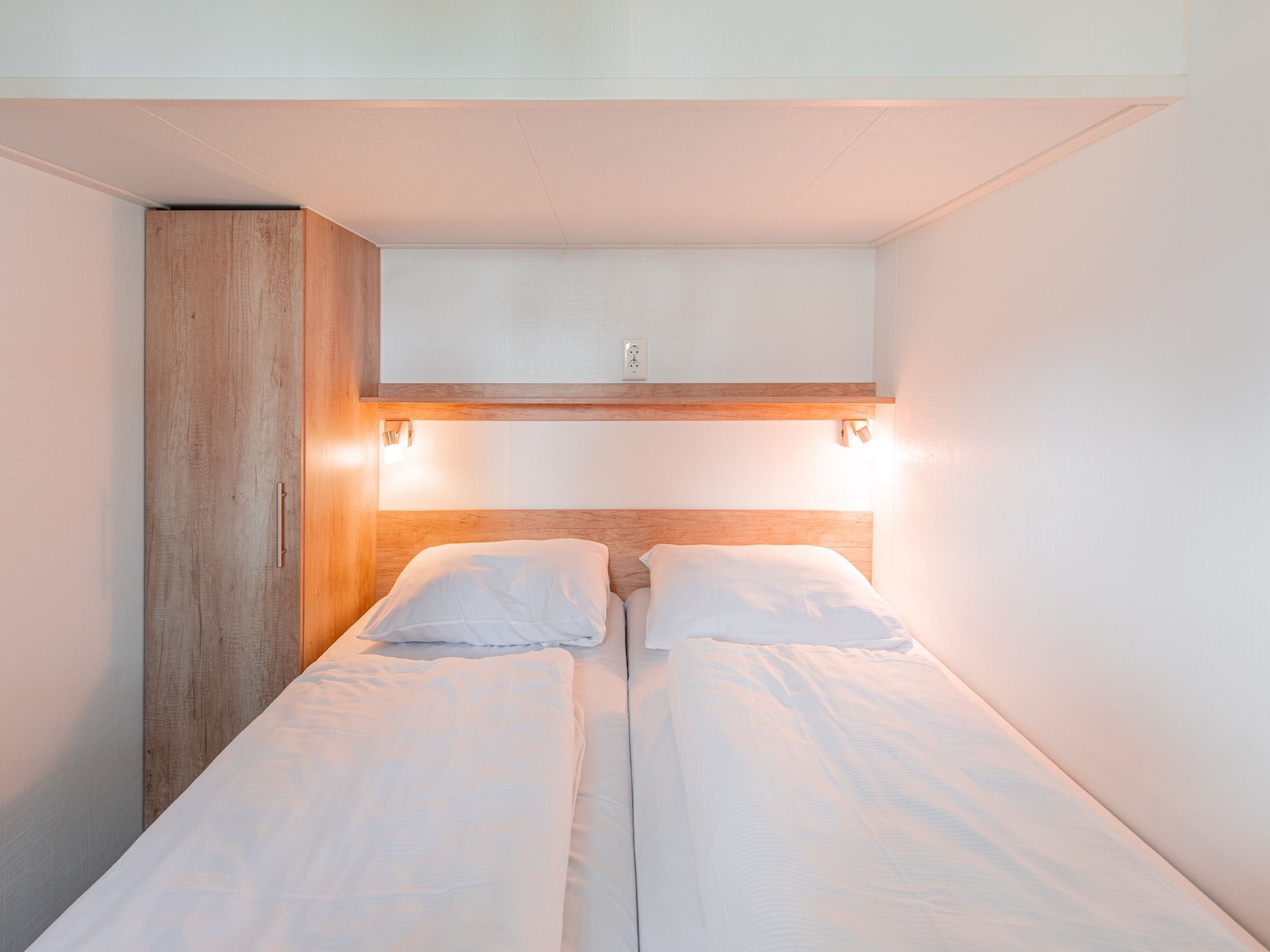 Een slaapkamer van Vakantiepark Leukermeer 12 in Well