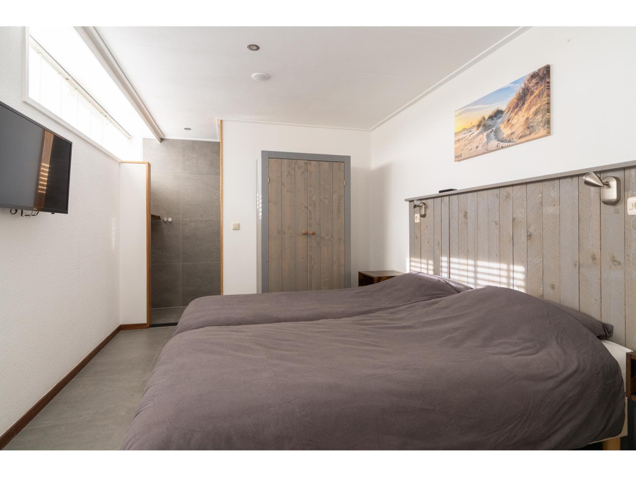 Een slaapkamer van Golfvilla 39 Wellness in Hollum