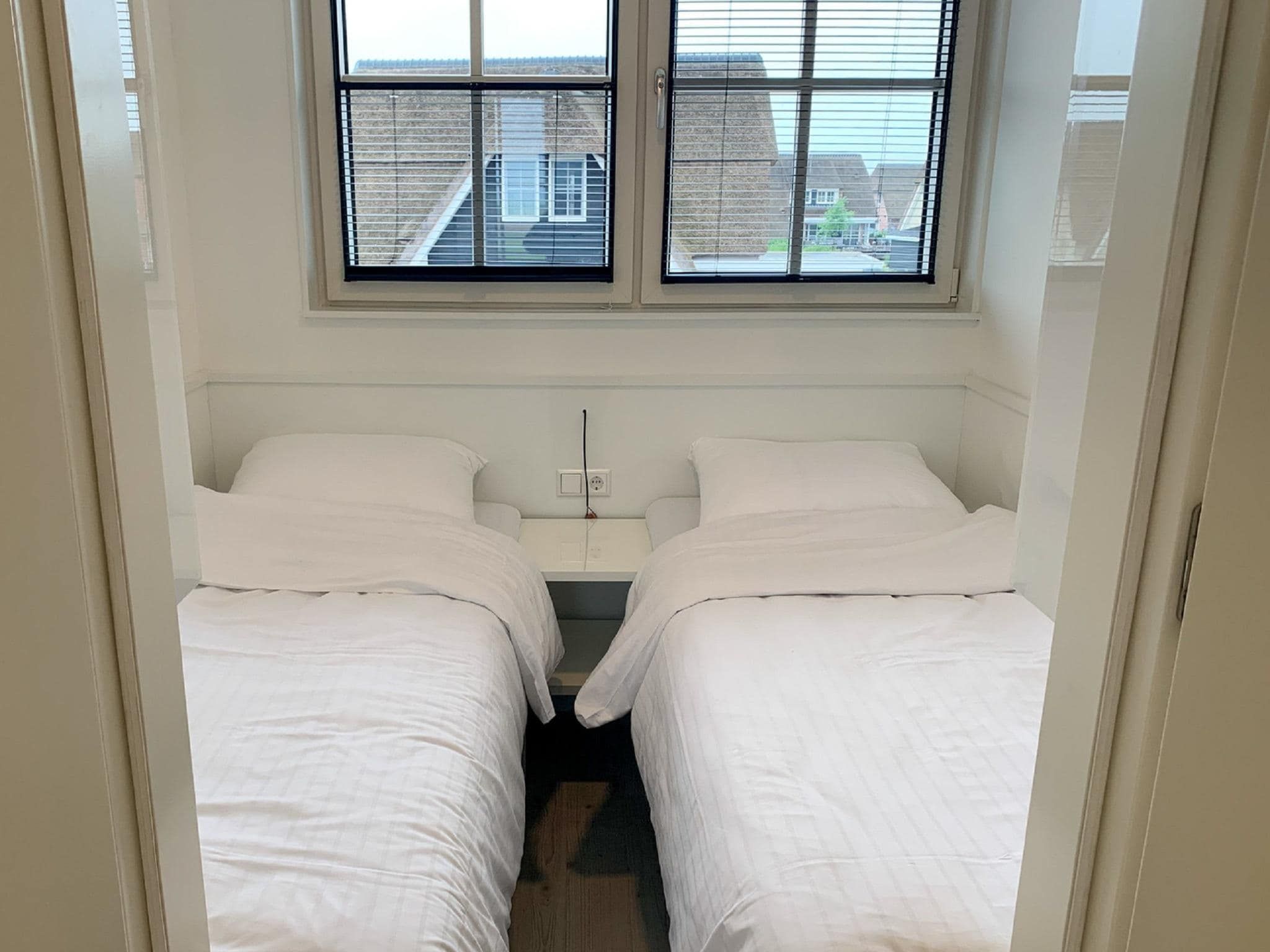 Een slaapkamer van Friese Meren Villa's 20 in Delfstrahuizen