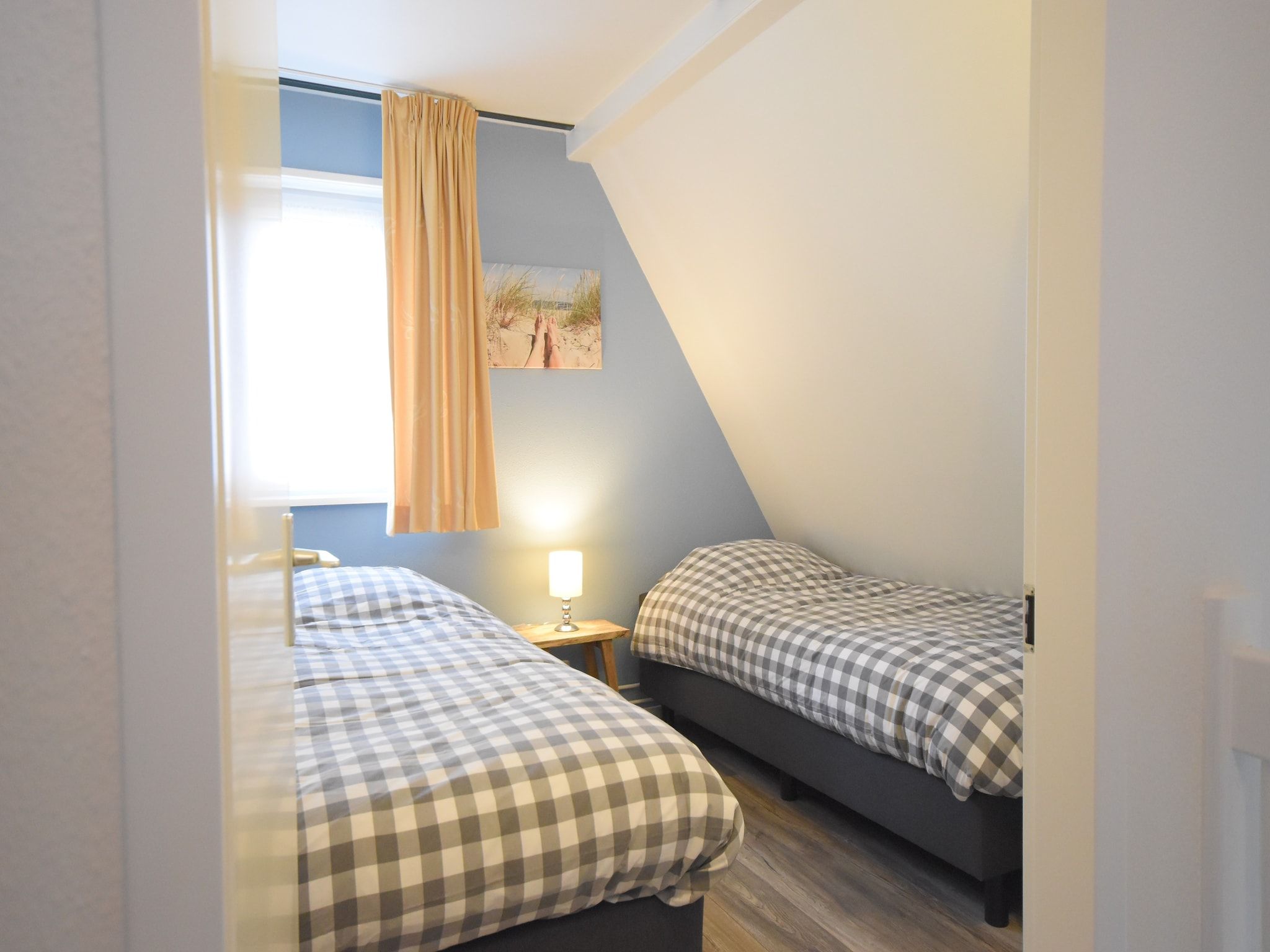 Een slaapkamer van Bungalowpark Campanula 5 in St. Maartenszee