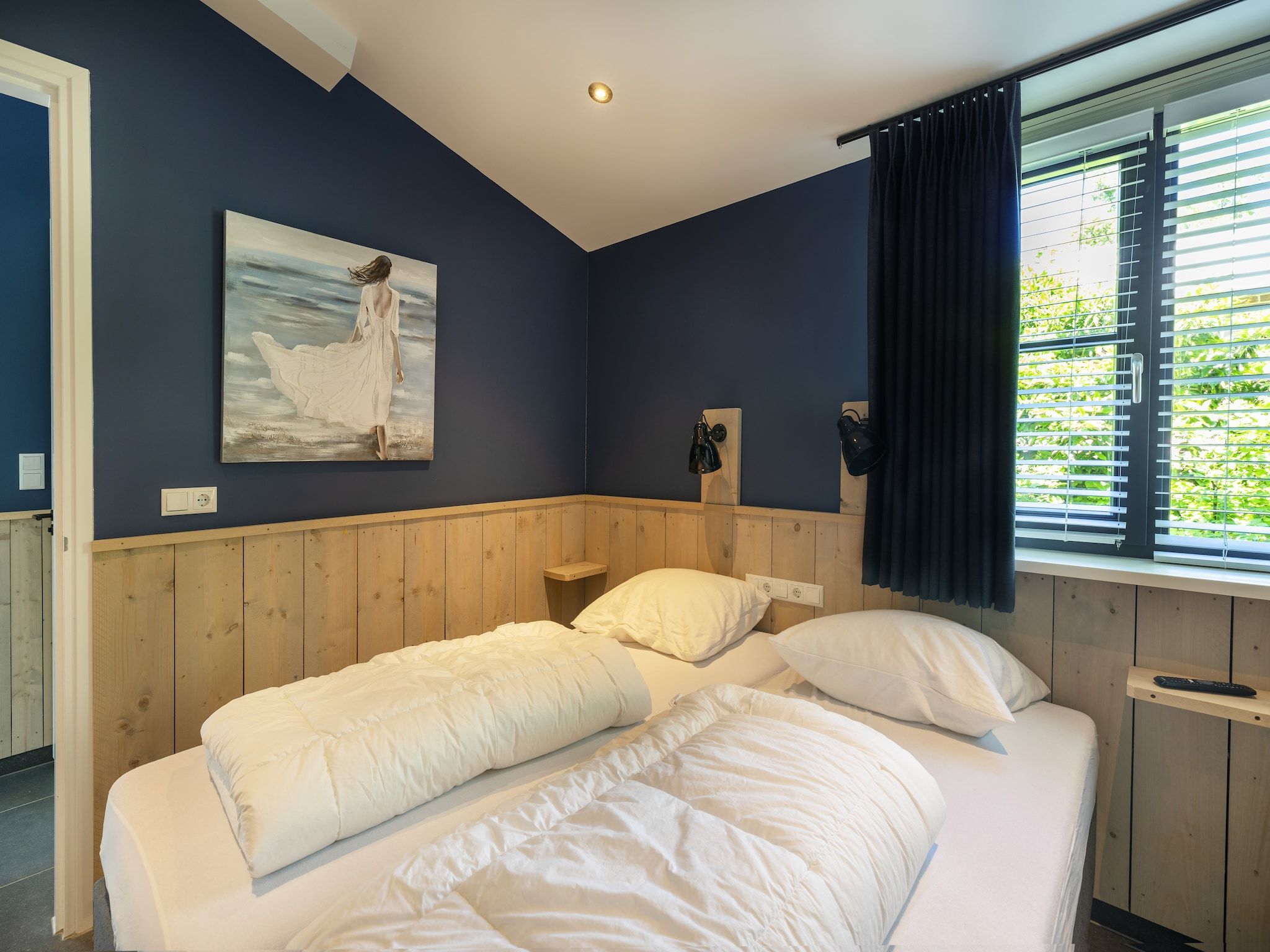 Een slaapkamer van Bungalowpark Campanula 8 in St. Maartenszee