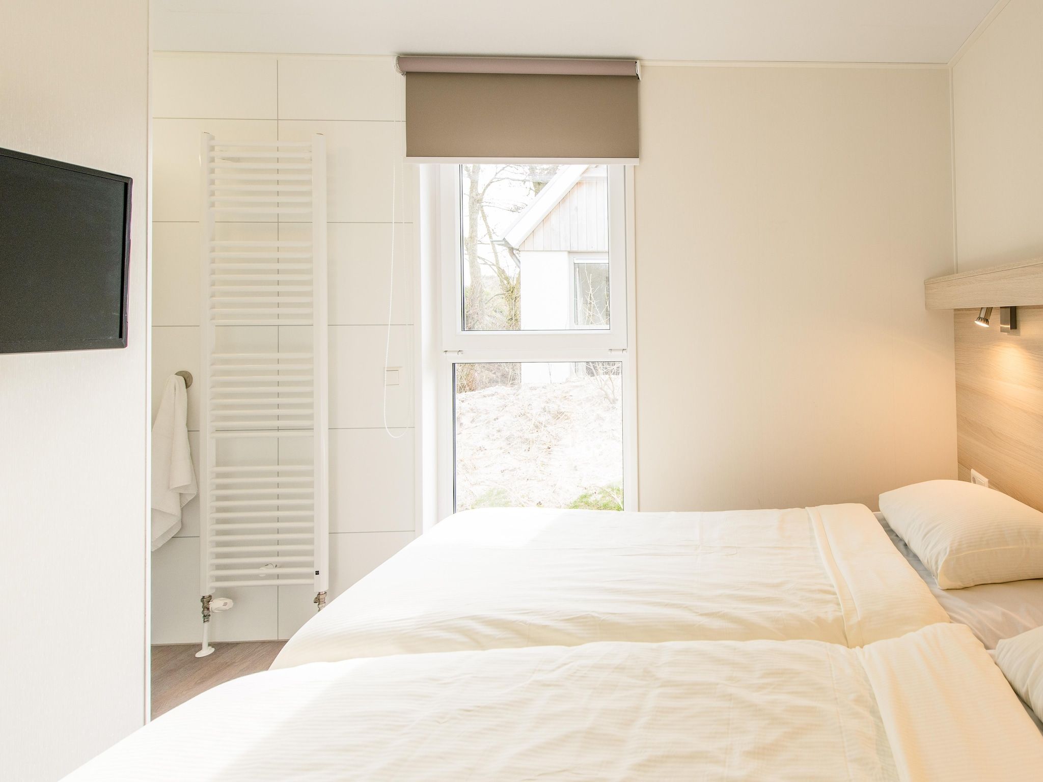 Een slaapkamer van Vakantiepark Boomhiemke 19 in Hollum