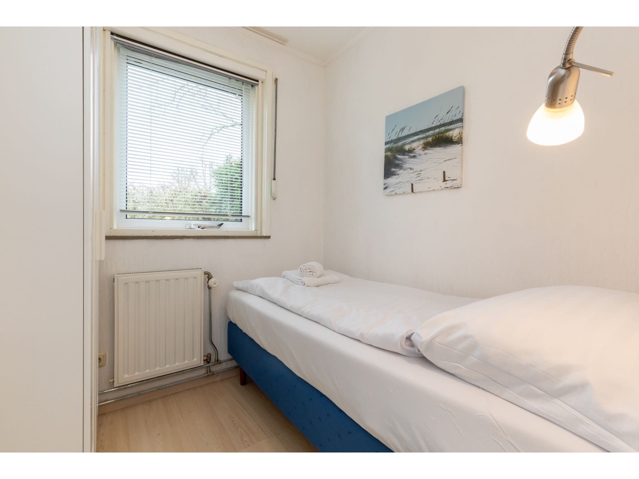 Een slaapkamer van Koekoesbloemwei 90 in Kortgene