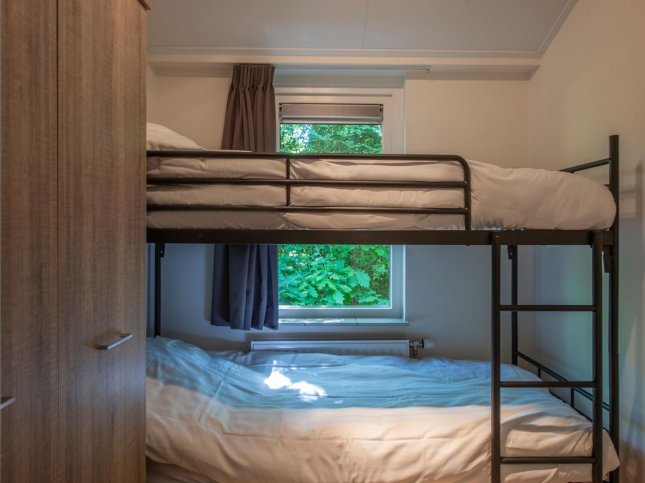 Een slaapkamer van Bospark de Schaapskooi 10 in Wissel/Epe