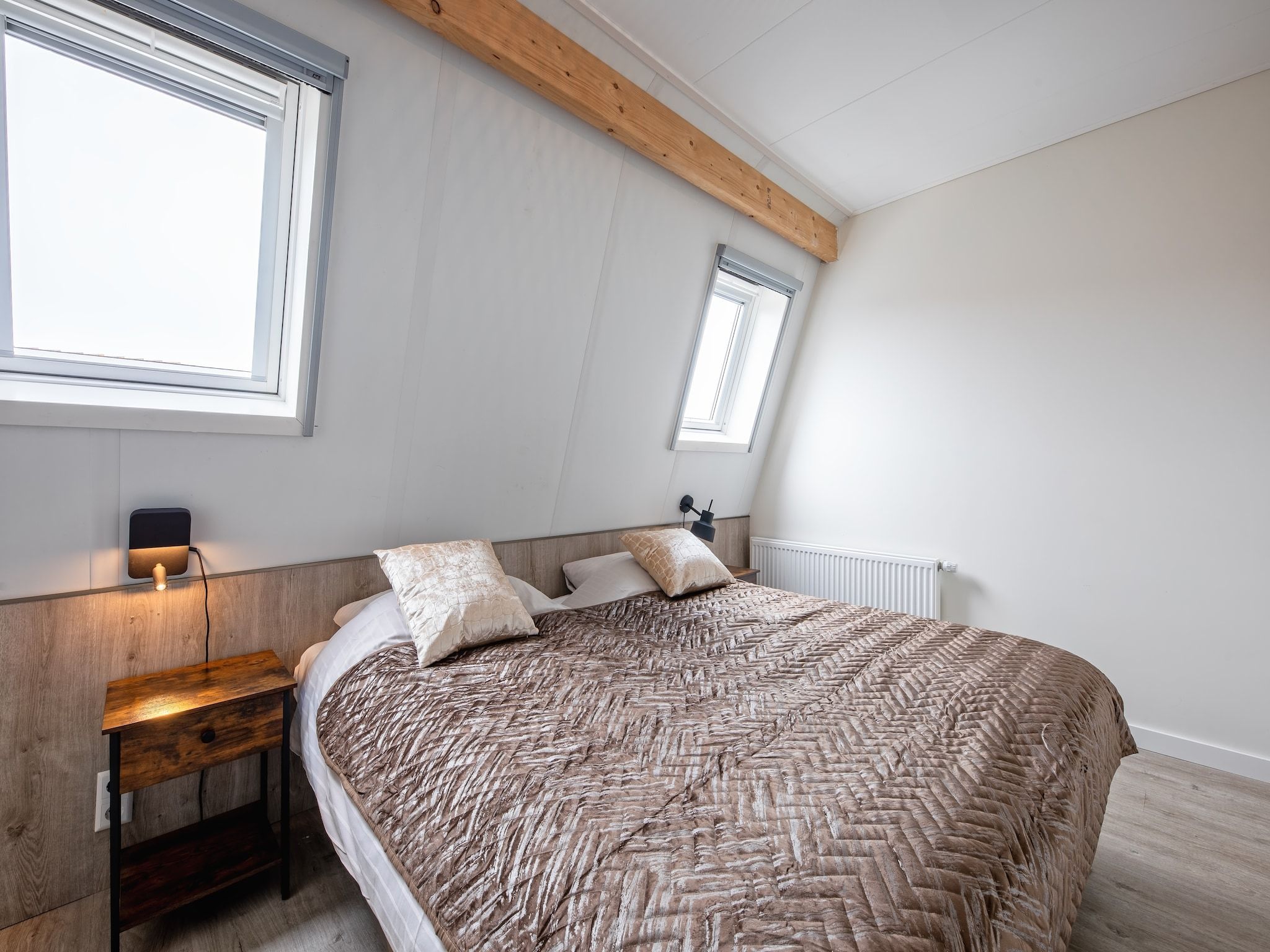 Een slaapkamer van Wulpenweid 10 in Den Burg