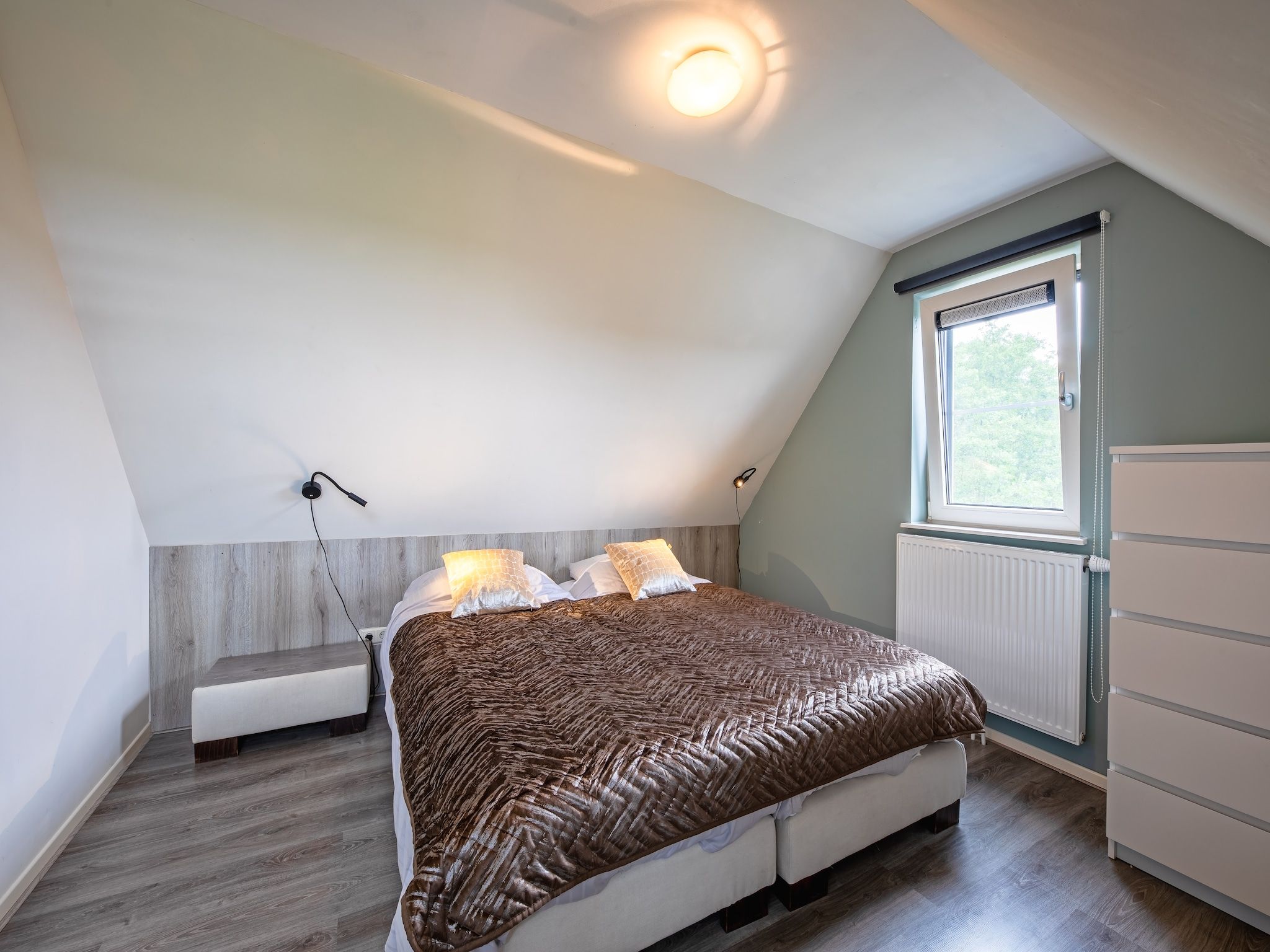 Een slaapkamer van Wulpenweid 12 in Den Burg