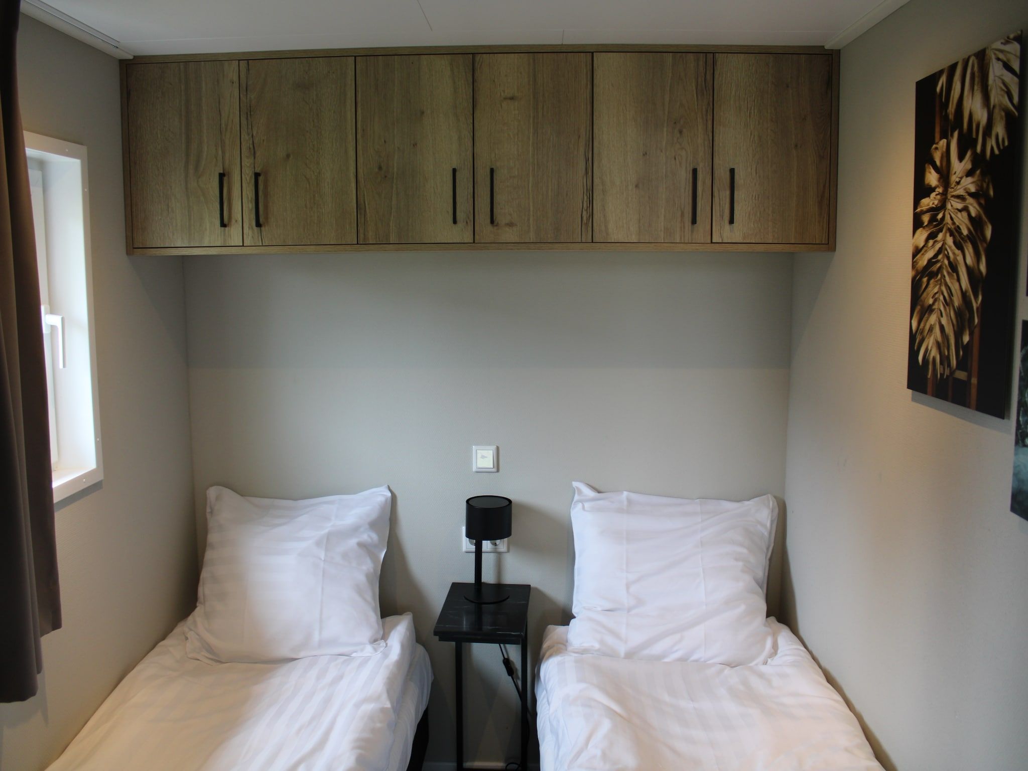 Een slaapkamer van Recreatiepark Rhederlaagse Meren 20 in Lathum