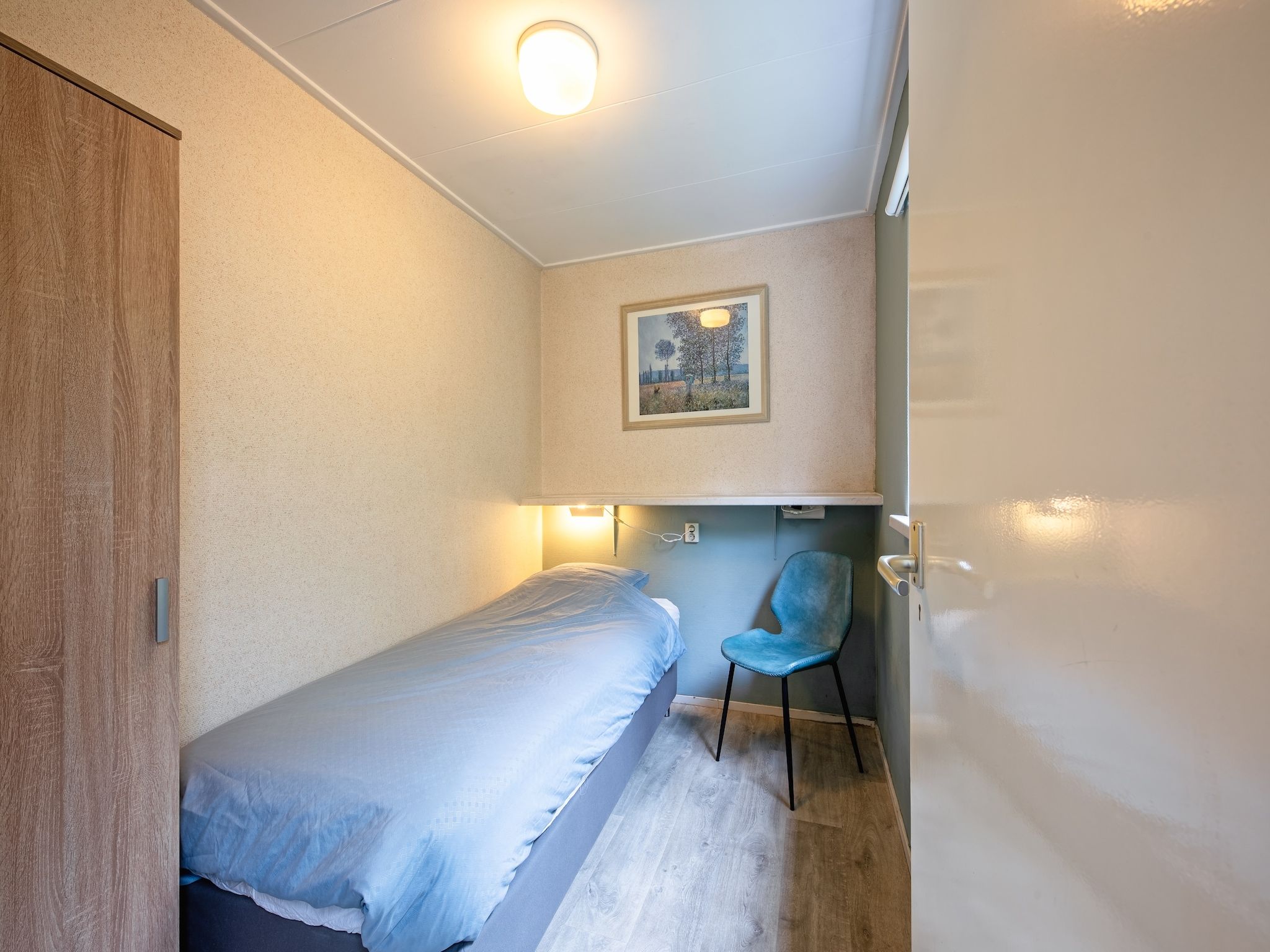 Een slaapkamer van De Parel 166 in Den Burg