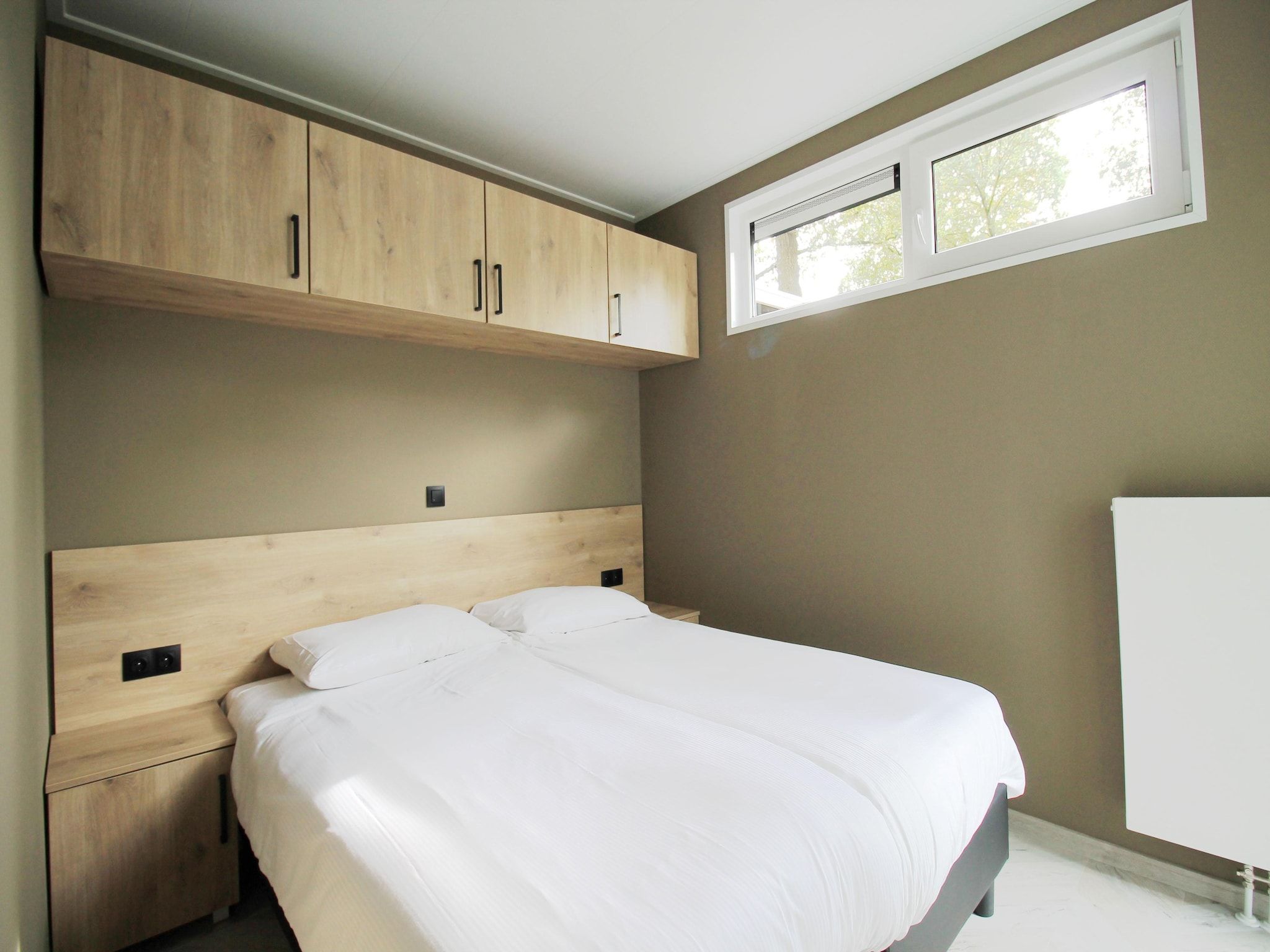 Een slaapkamer van Vakantiepark De Rimboe & De Woeste Hoogte 42 in Hoenderloo