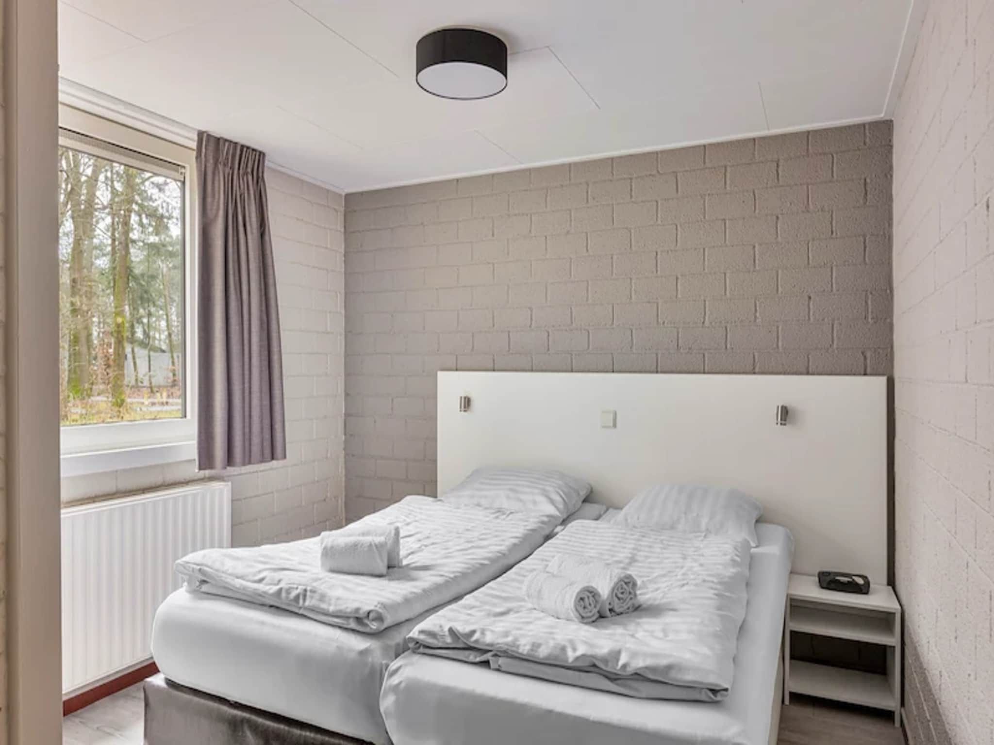 Een slaapkamer van Vakantiepark de Berkenhorst 13 in Kootwijk