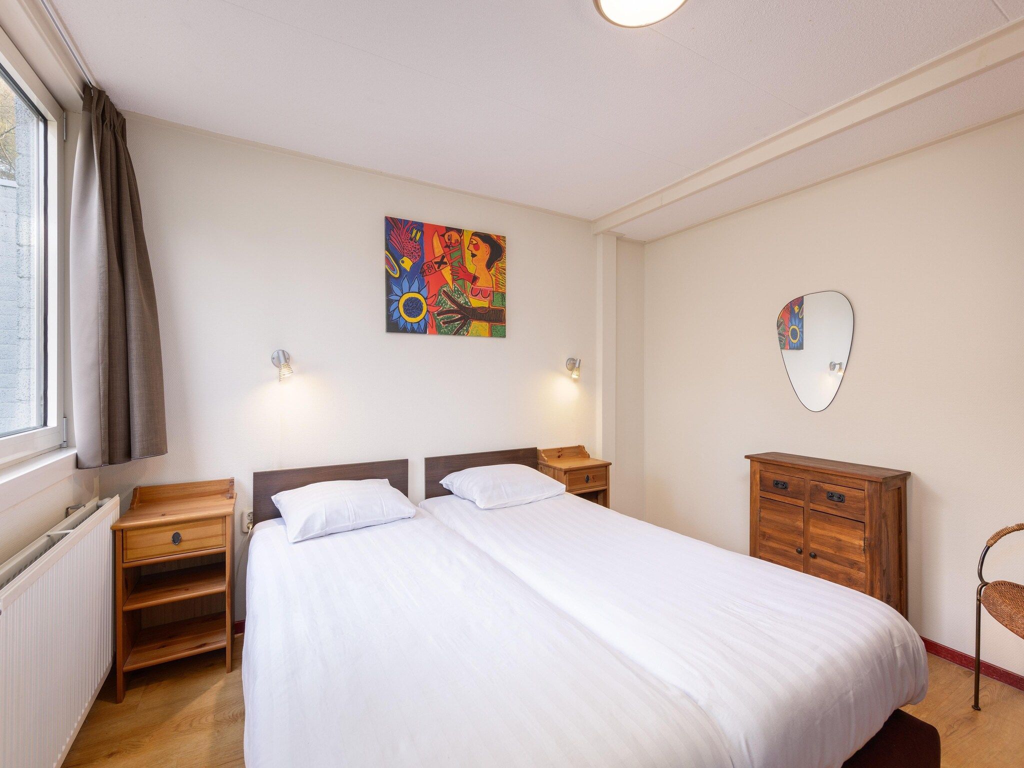 Een slaapkamer van Vakantiepark de Berkenhorst 16 in Kootwijk