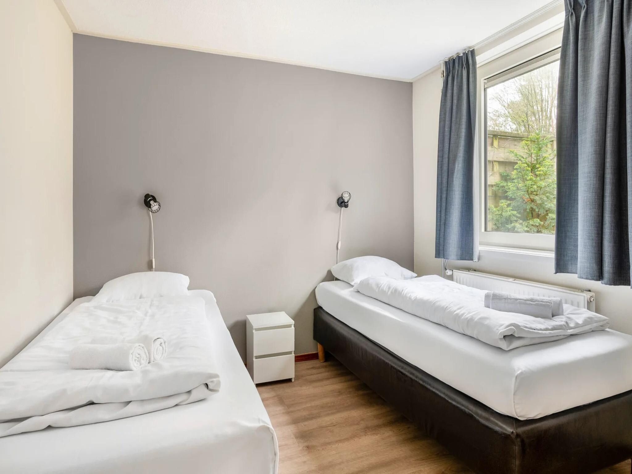 Een slaapkamer van Vakantiepark de Berkenhorst 19 in Kootwijk