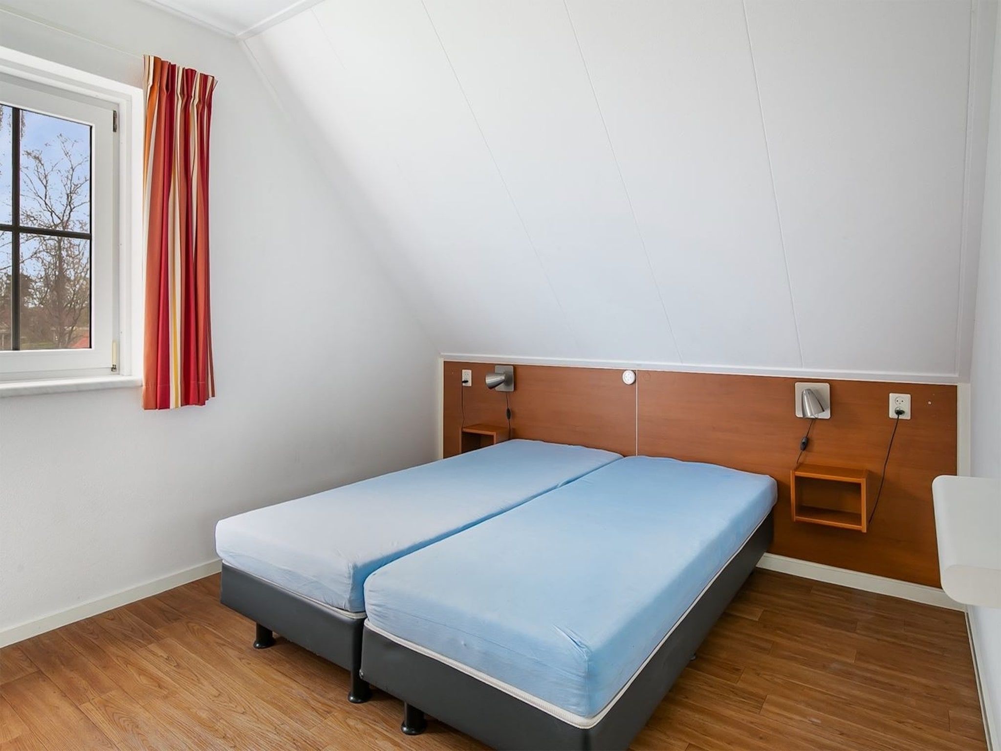 Een slaapkamer van Vakantiepark Hellendoorn 6 in Hellendoorn
