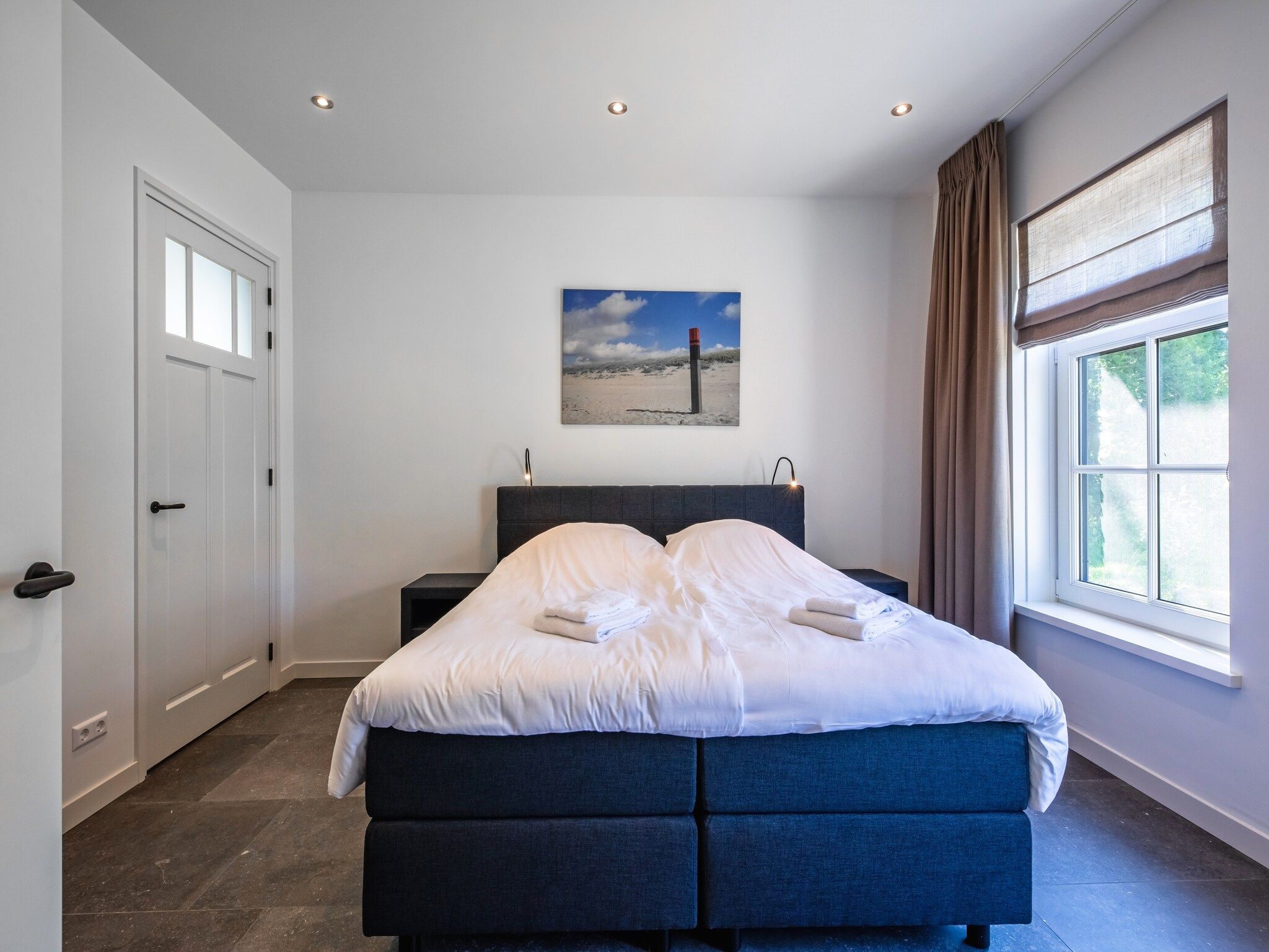 Een slaapkamer van Familievilla Nieuw-Zeeland in Oosterend