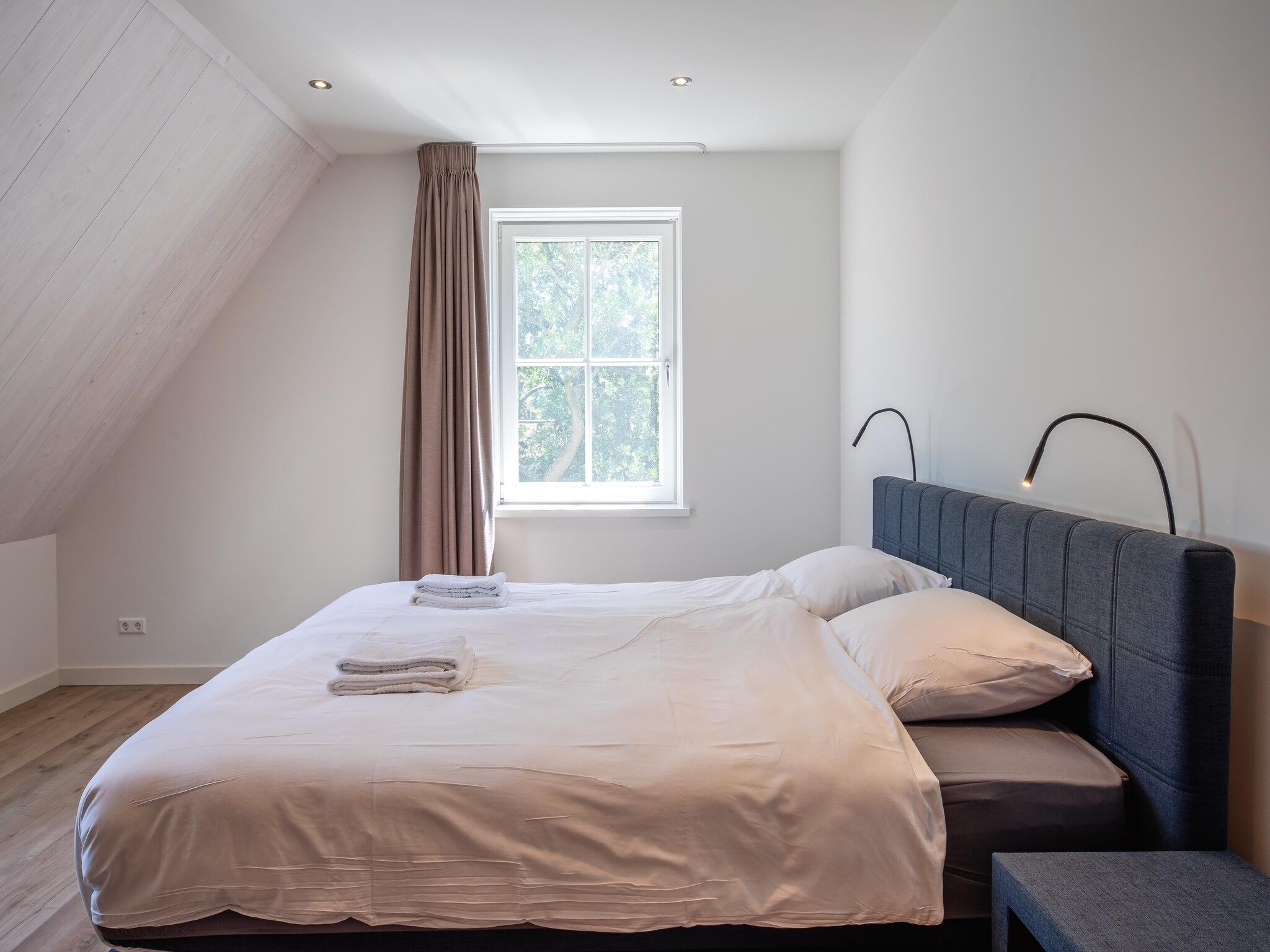 Een slaapkamer van Familievilla Nieuw-Zeeland in Oosterend