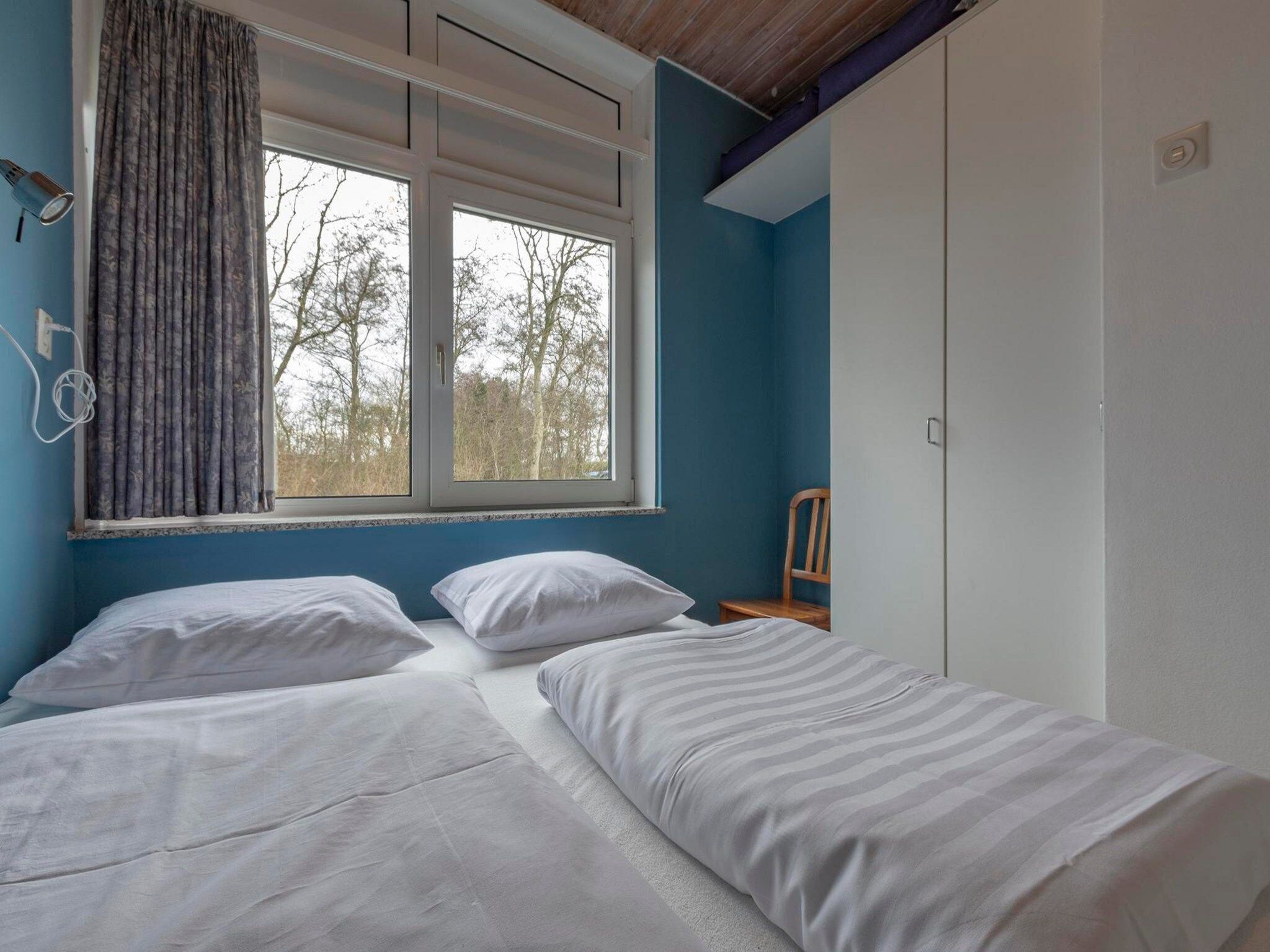 Een slaapkamer van Duinland 90 in Sint Maartenszee