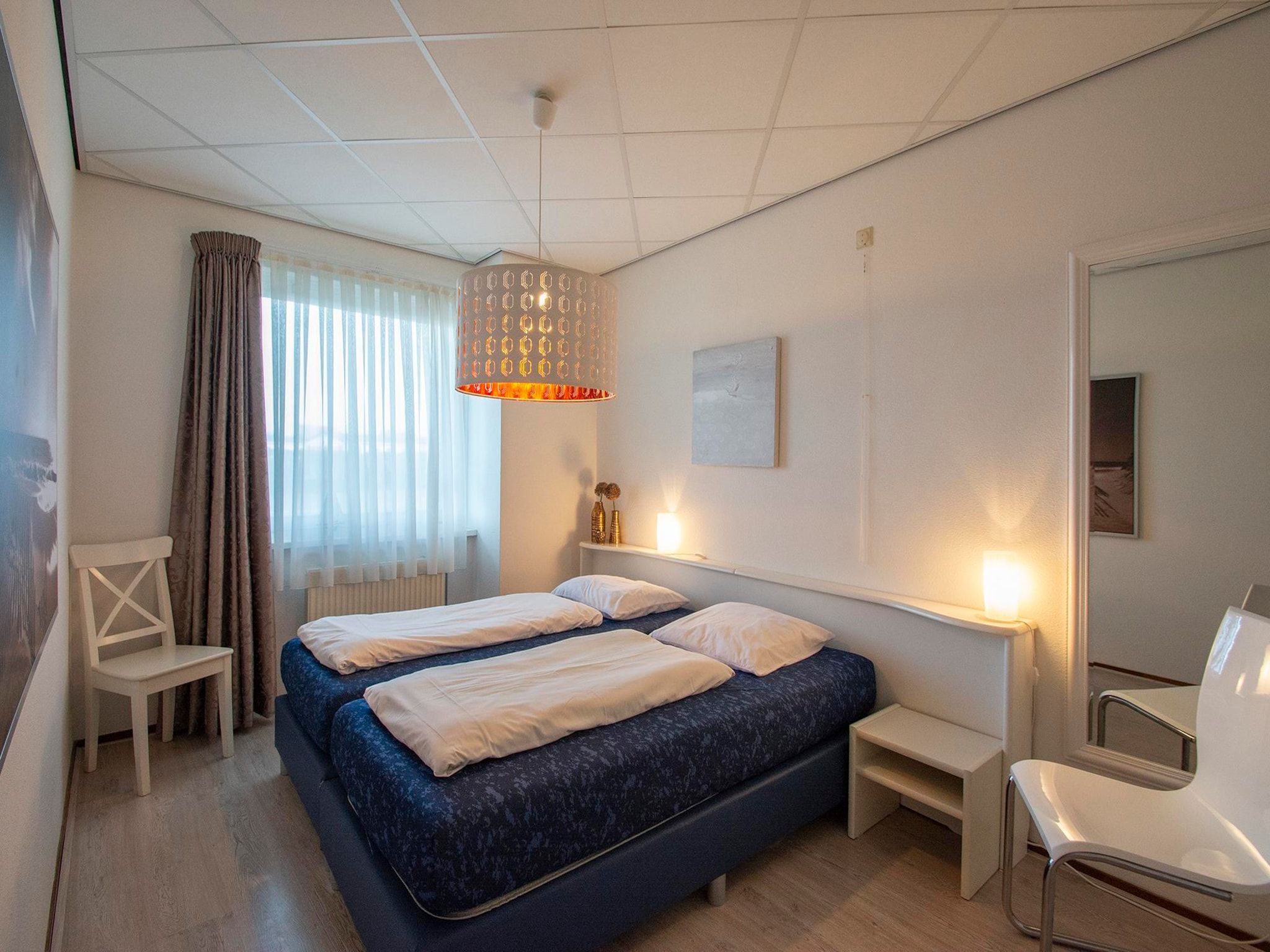 Een slaapkamer van Strandslag 107 in Julianadorp aan Zee