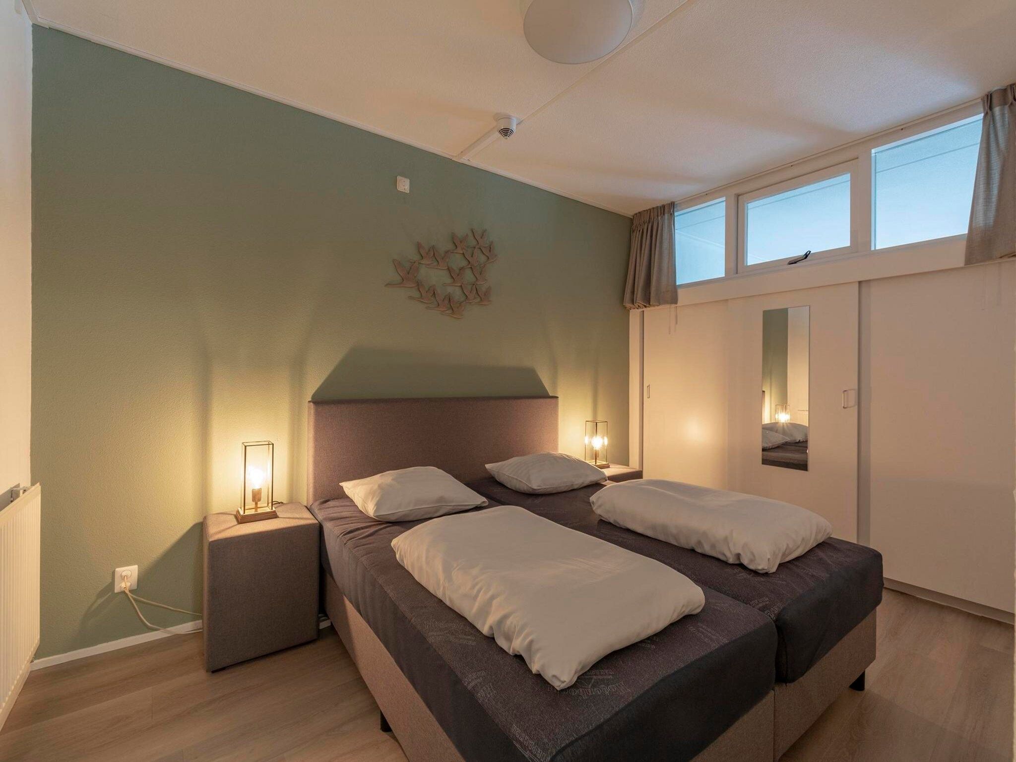 Een slaapkamer van Strandslag 203 in Julianadorp aan Zee