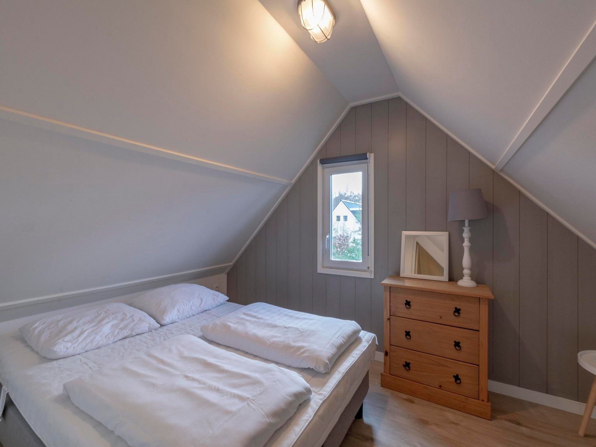 Een slaapkamer van Belkmerduinen 12 in Sint Maartenszee