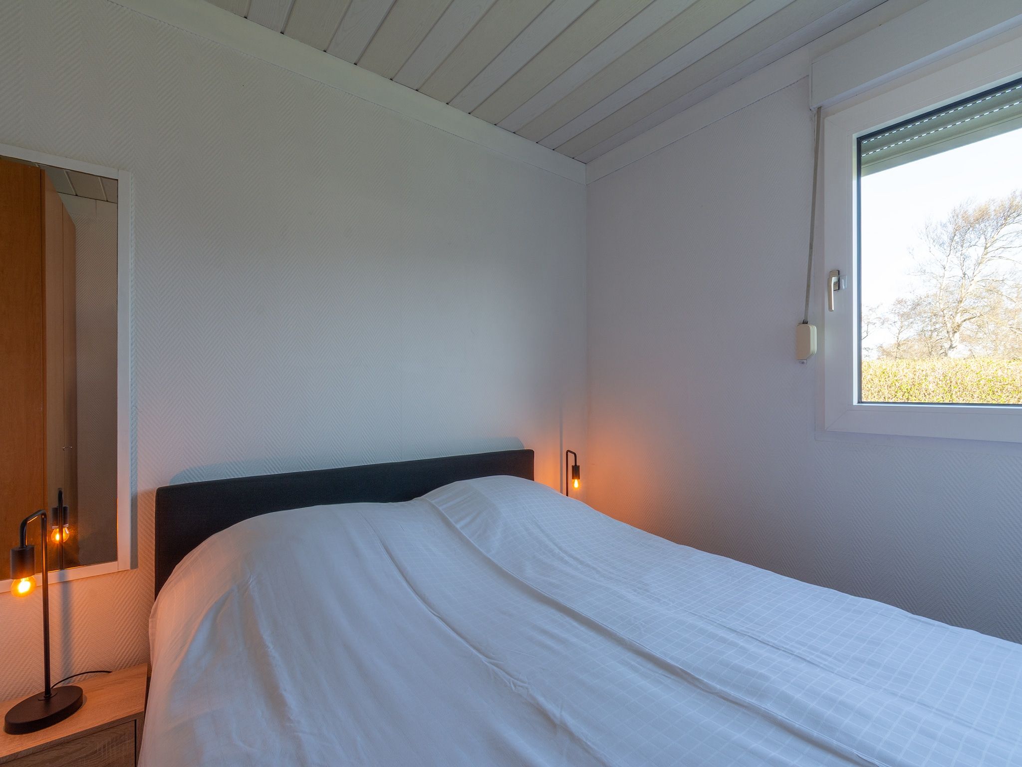 Een slaapkamer van Keizerskroon 58 in Julianadorp aan Zee