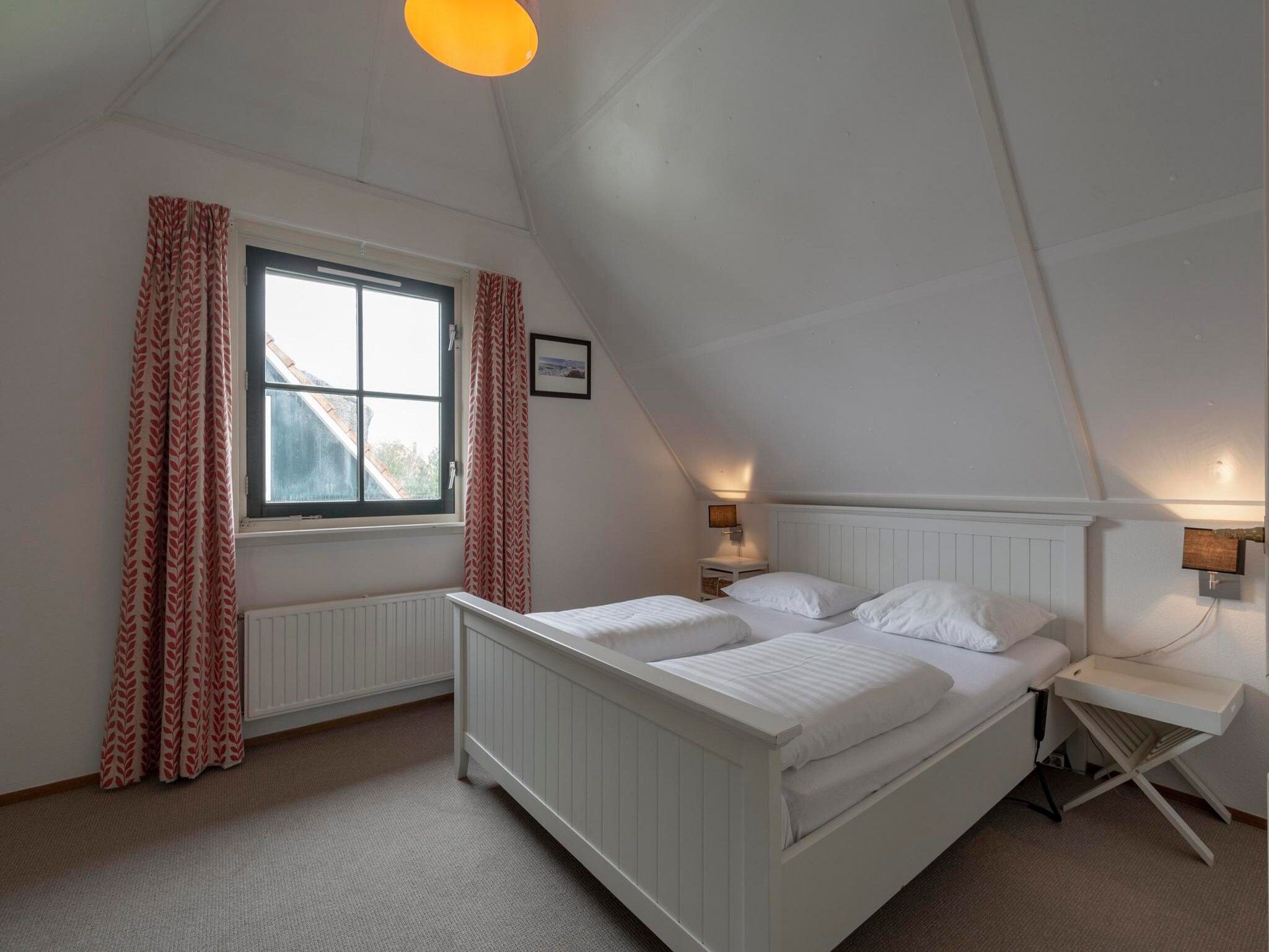 Een slaapkamer van De Buitenplaats 116 in Callantsoog