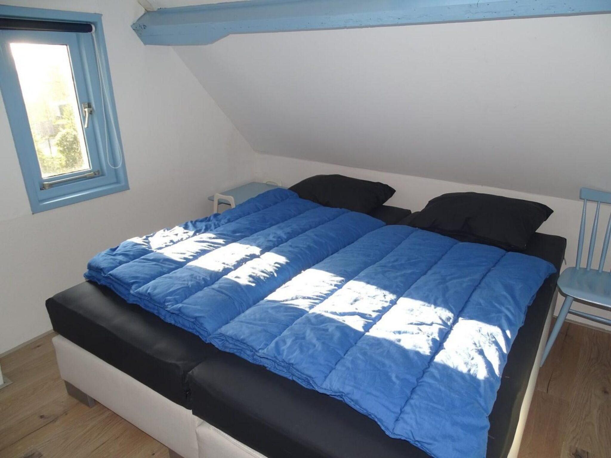 Een slaapkamer van Tragel 37 Schoondijke in Schoondijke