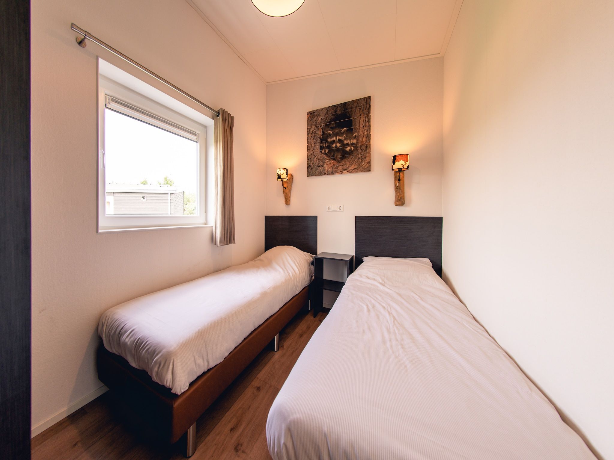 Een slaapkamer van Raccoon Lodge in Slagharen