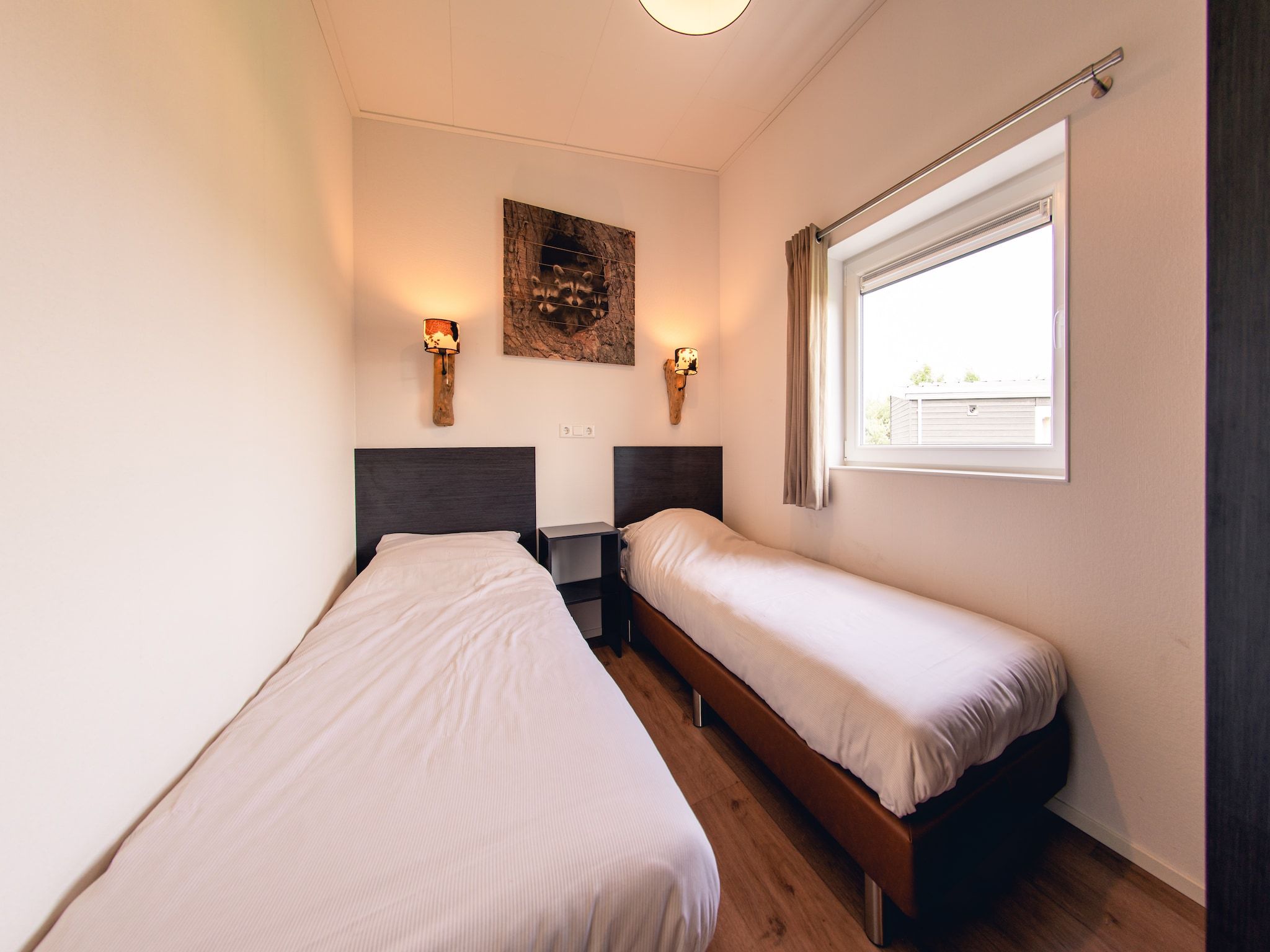 Een slaapkamer van Raccoon Lodge in Slagharen