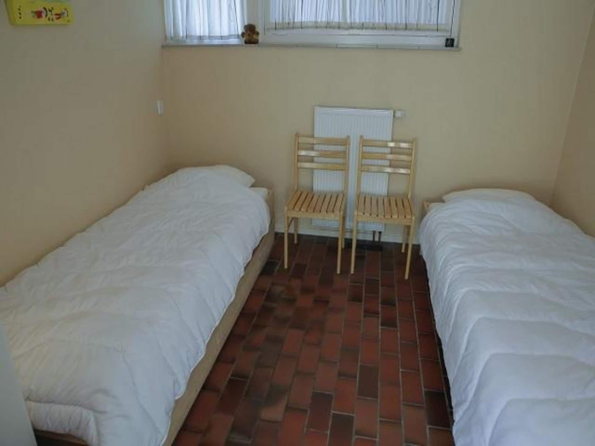 Een slaapkamer van De Schelp 14 in Sint Maartenszee